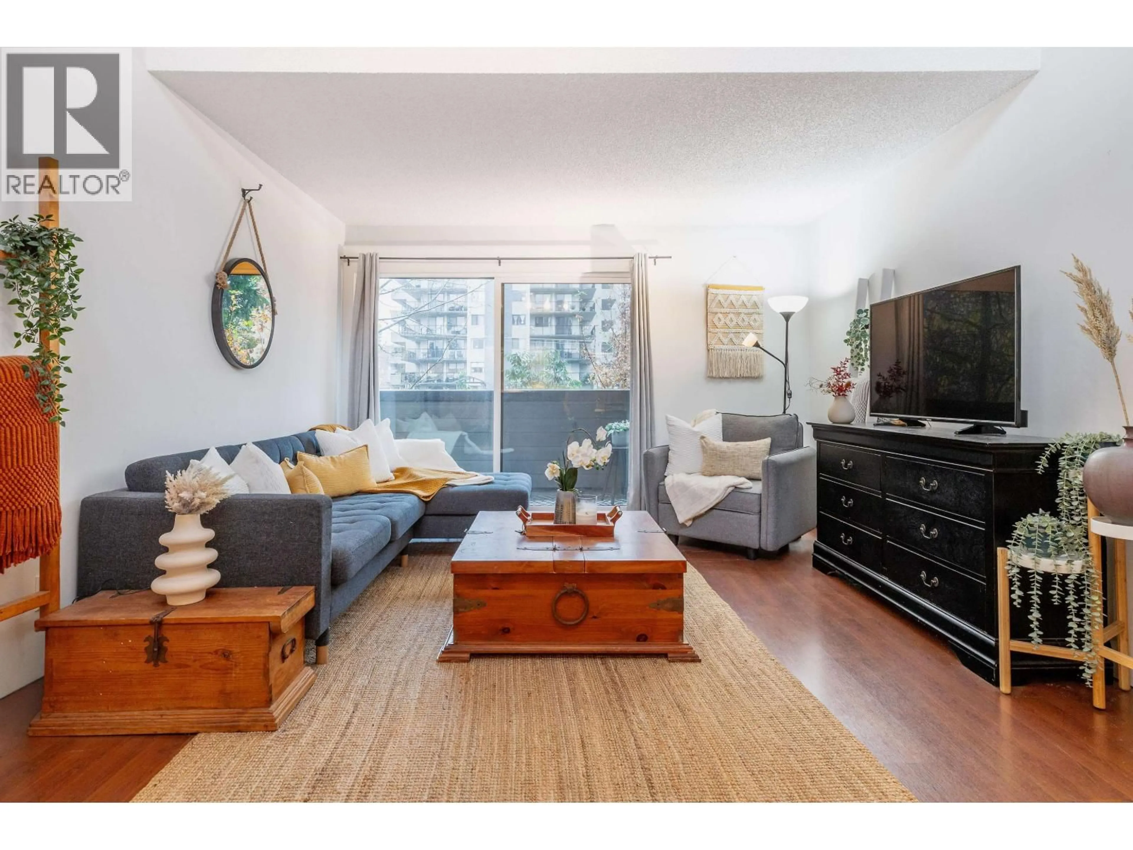 Living room with furniture, wood/laminate floor for 319 - 206 15TH STREET, North Vancouver British Columbia V7L2R3