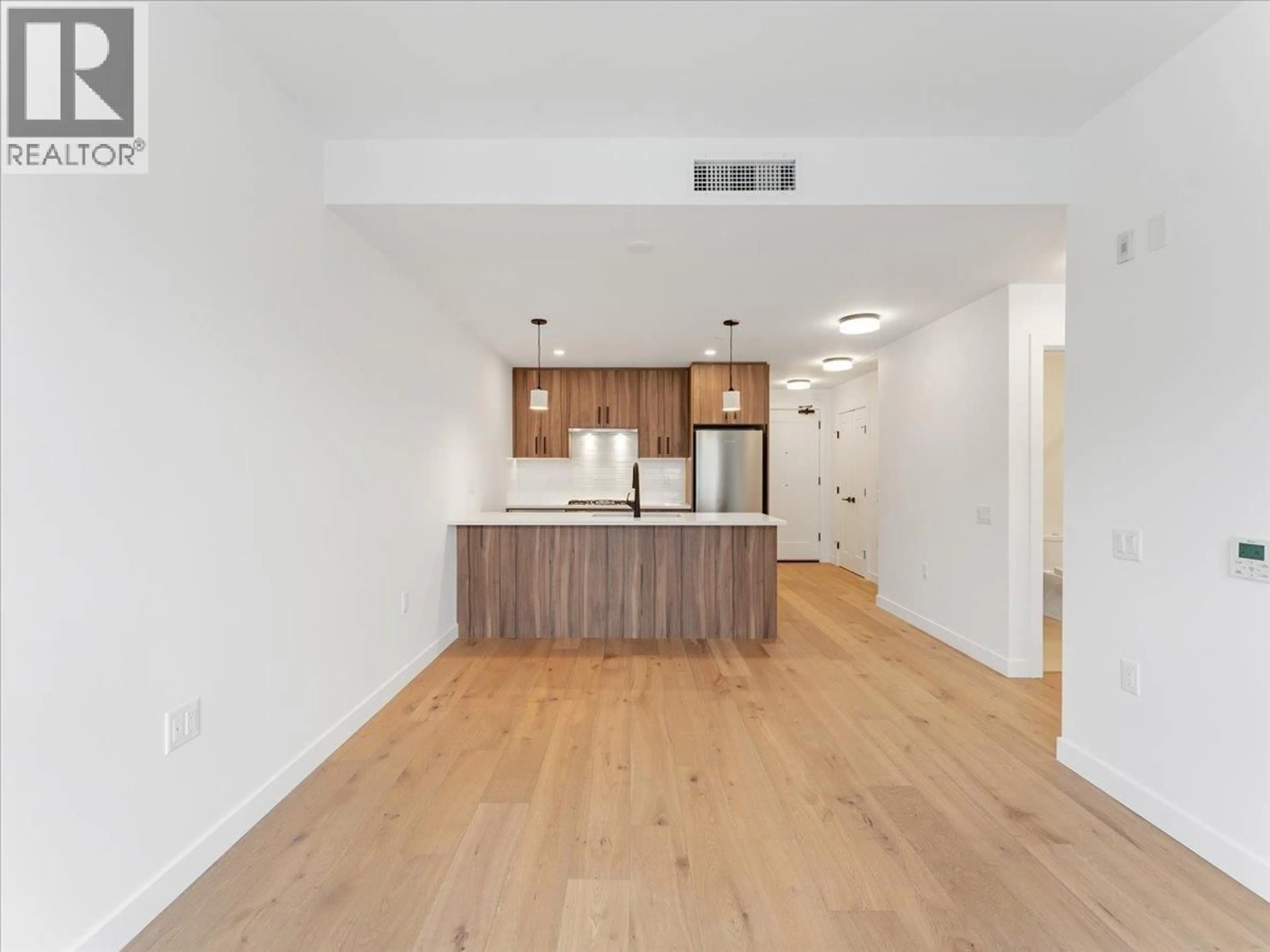 Open concept kitchen, wood/laminate floor for 201 - 6859 CAMBIE STREET, Vancouver British Columbia V6P0M4