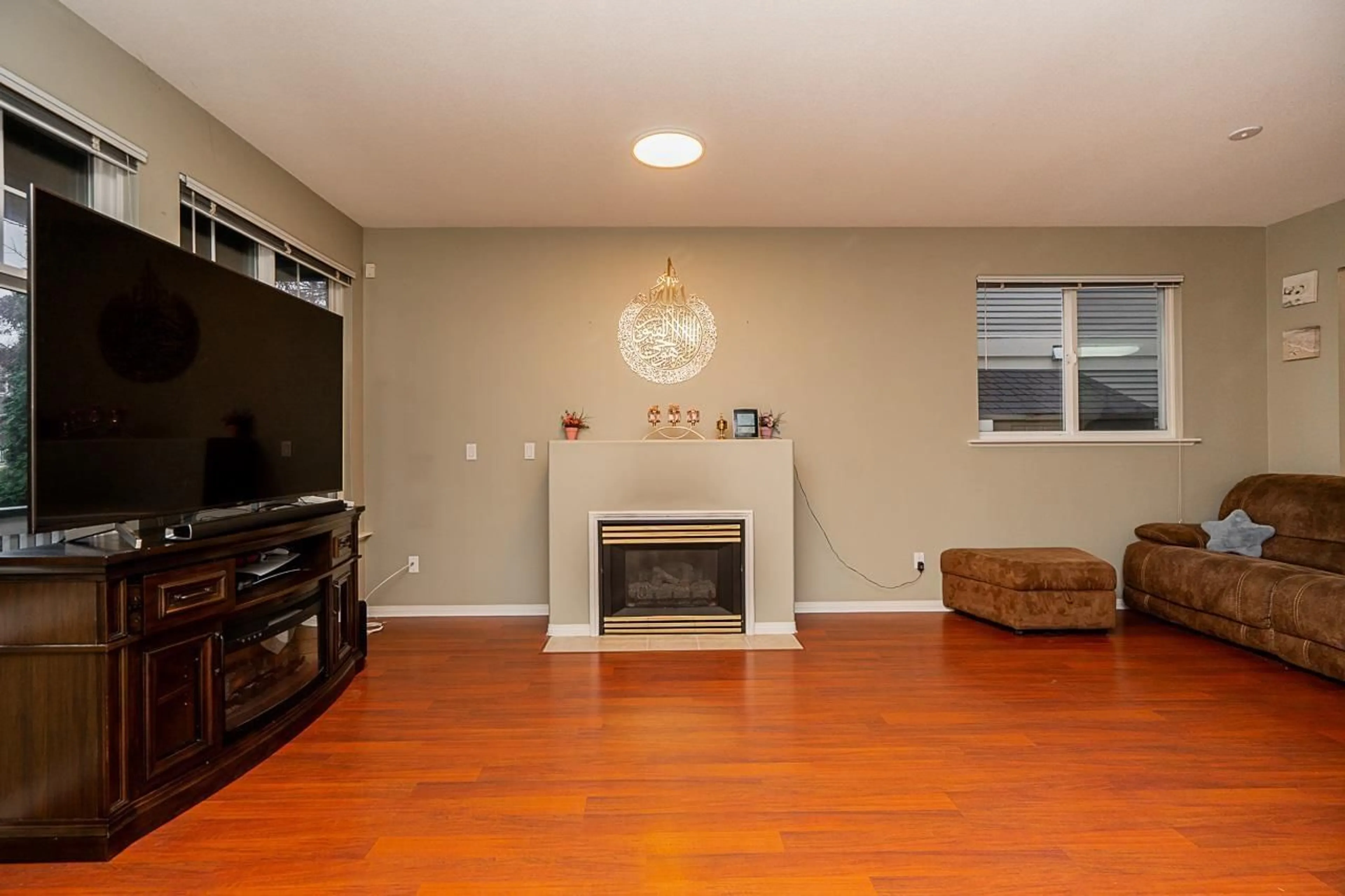 Living room with furniture, wood/laminate floor for 14858 58 AVENUE, Surrey British Columbia V3S8W4