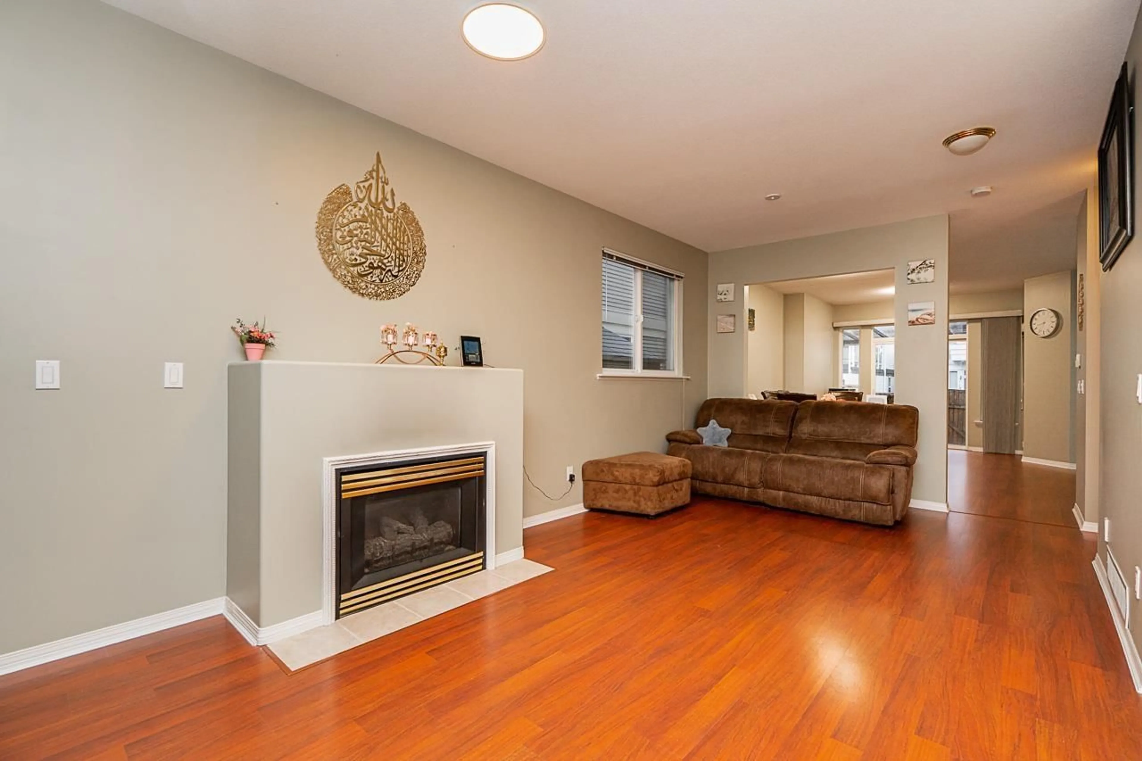 Living room with furniture, wood/laminate floor for 14858 58 AVENUE, Surrey British Columbia V3S8W4