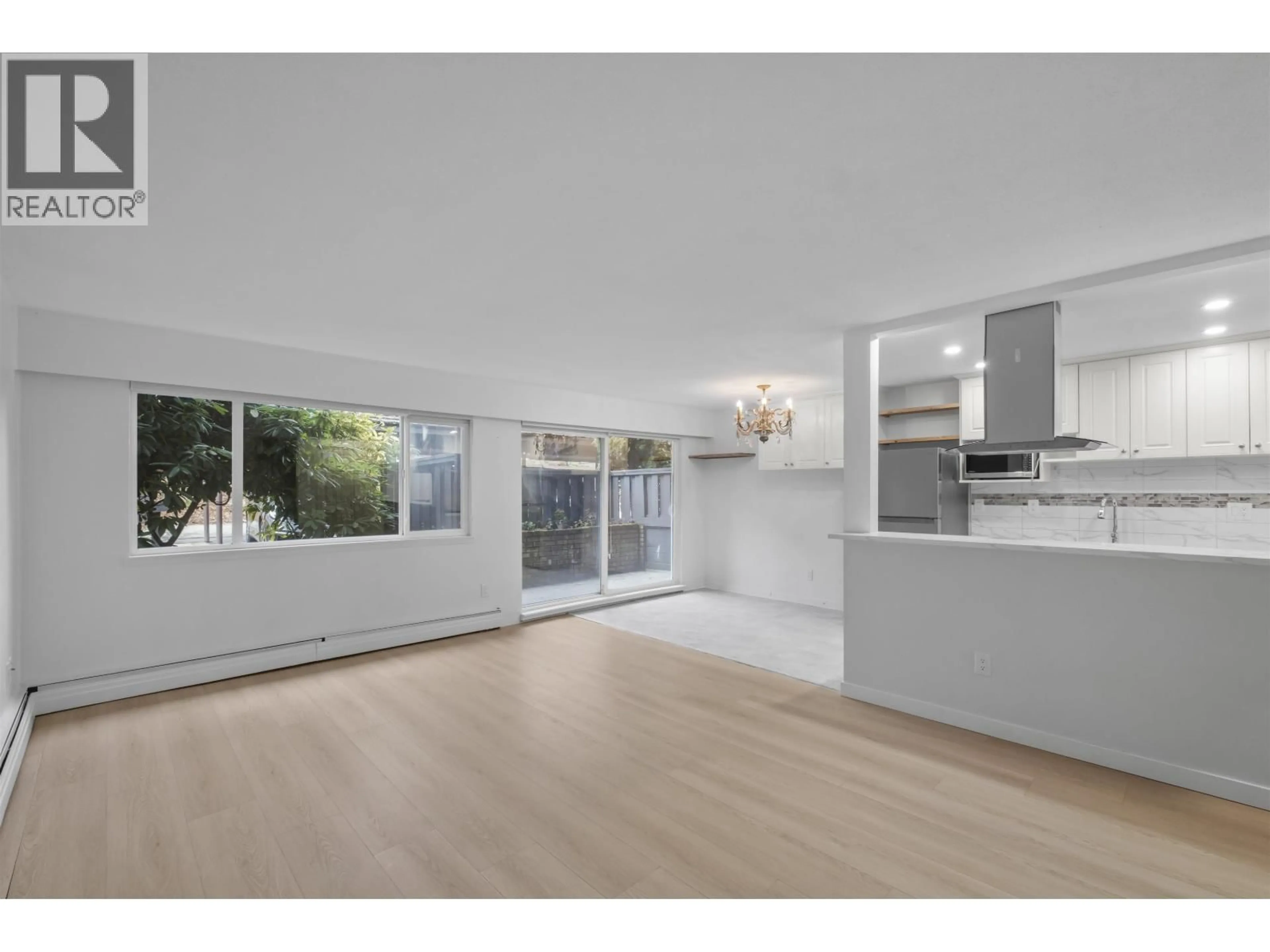 Open concept kitchen, wood/laminate floor for 609 - 555 28TH STREET, North Vancouver British Columbia V7N2J7