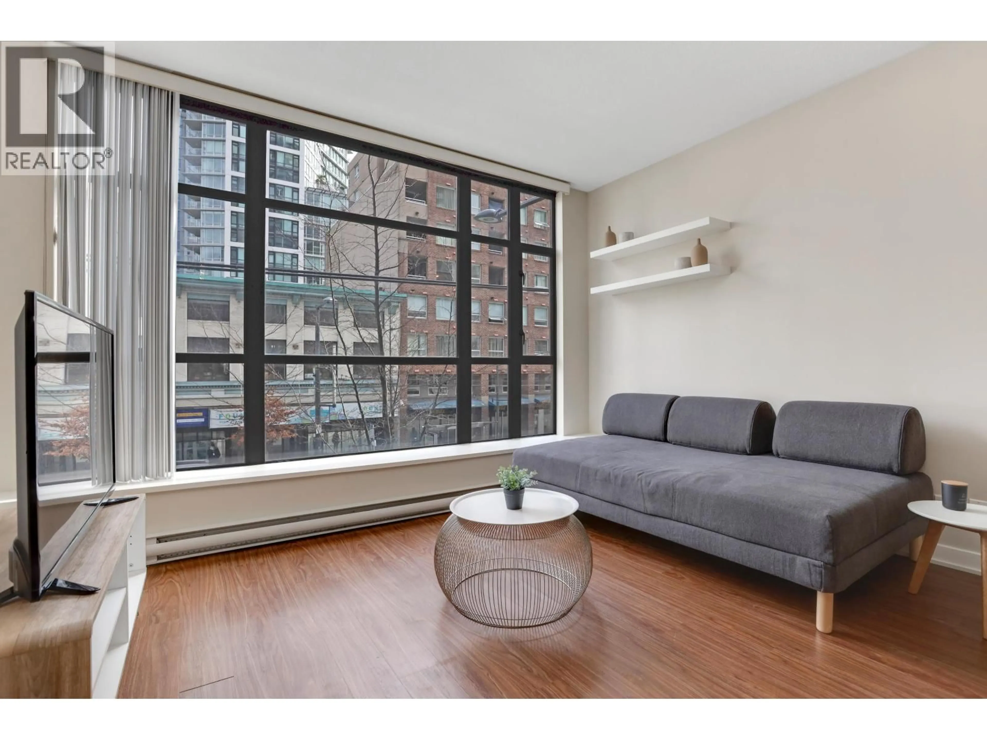 Living room with furniture, wood/laminate floor for 209 - 1249 GRANVILLE STREET, Vancouver British Columbia V6Z1M5