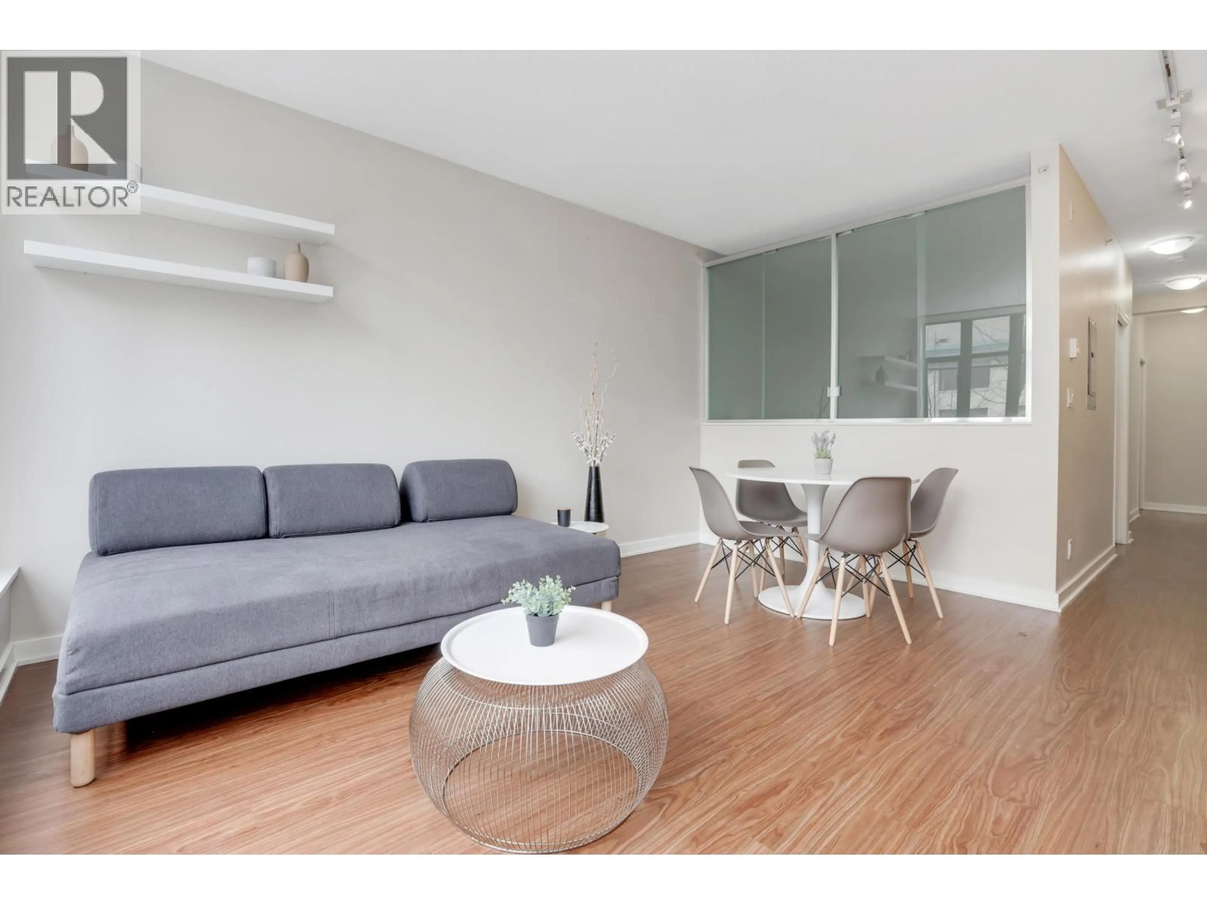 Living room with furniture, wood/laminate floor for 209 - 1249 GRANVILLE STREET, Vancouver British Columbia V6Z1M5