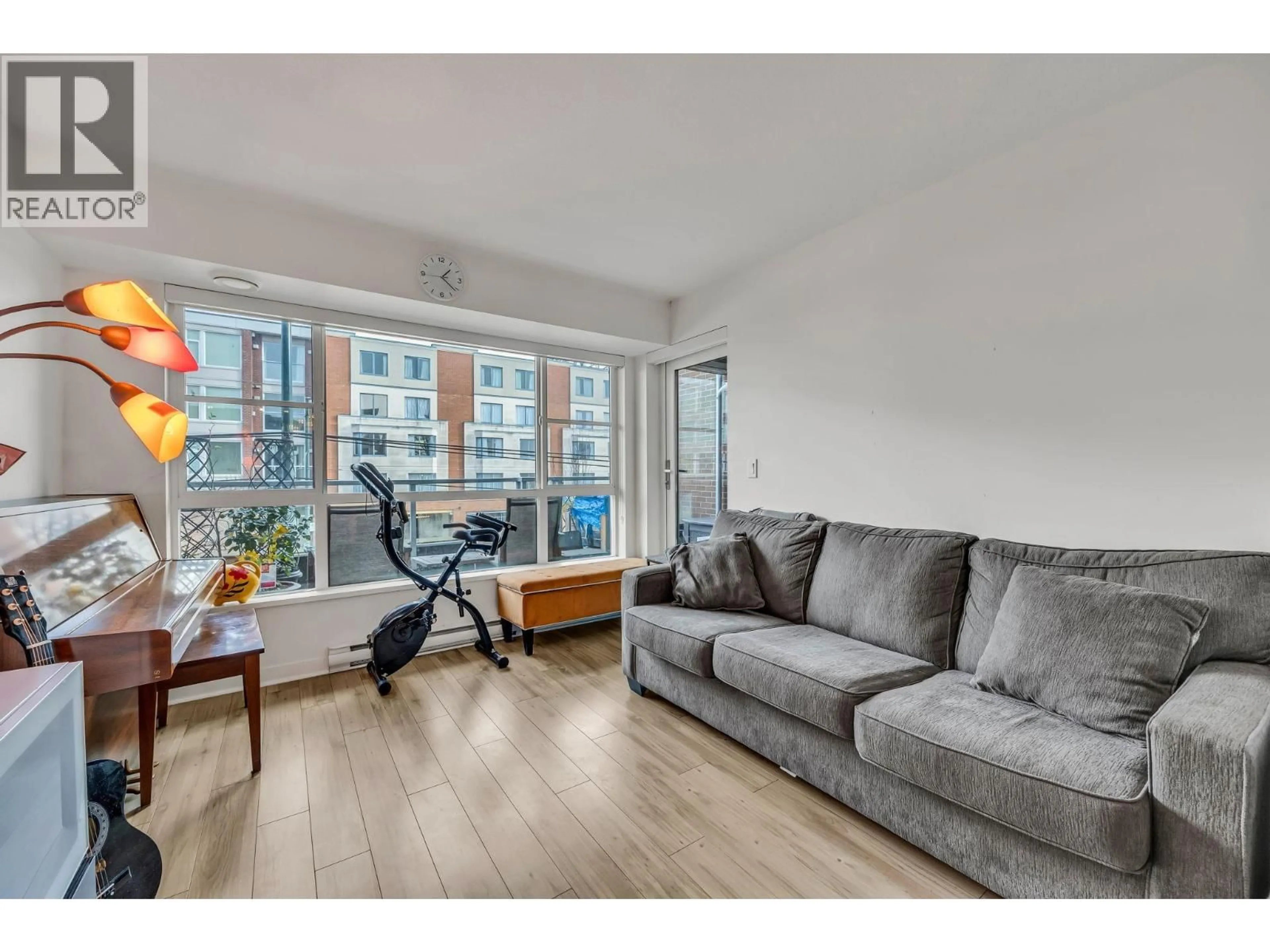 Living room with furniture, wood/laminate floor for 216 - 2888 2ND AVENUE, Vancouver British Columbia V5M0B9