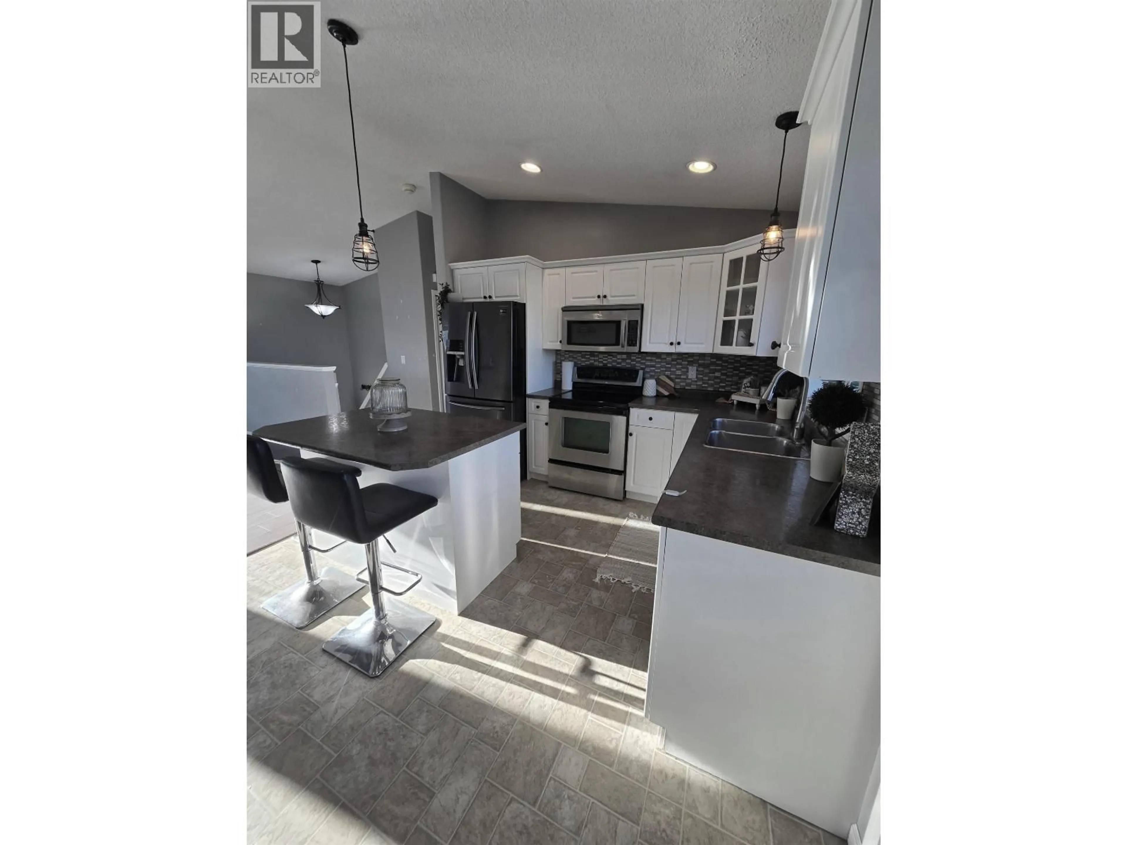 Open concept kitchen, ceramic/tile floor for 8724 114 AVENUE, Fort St. John British Columbia V1J0C3