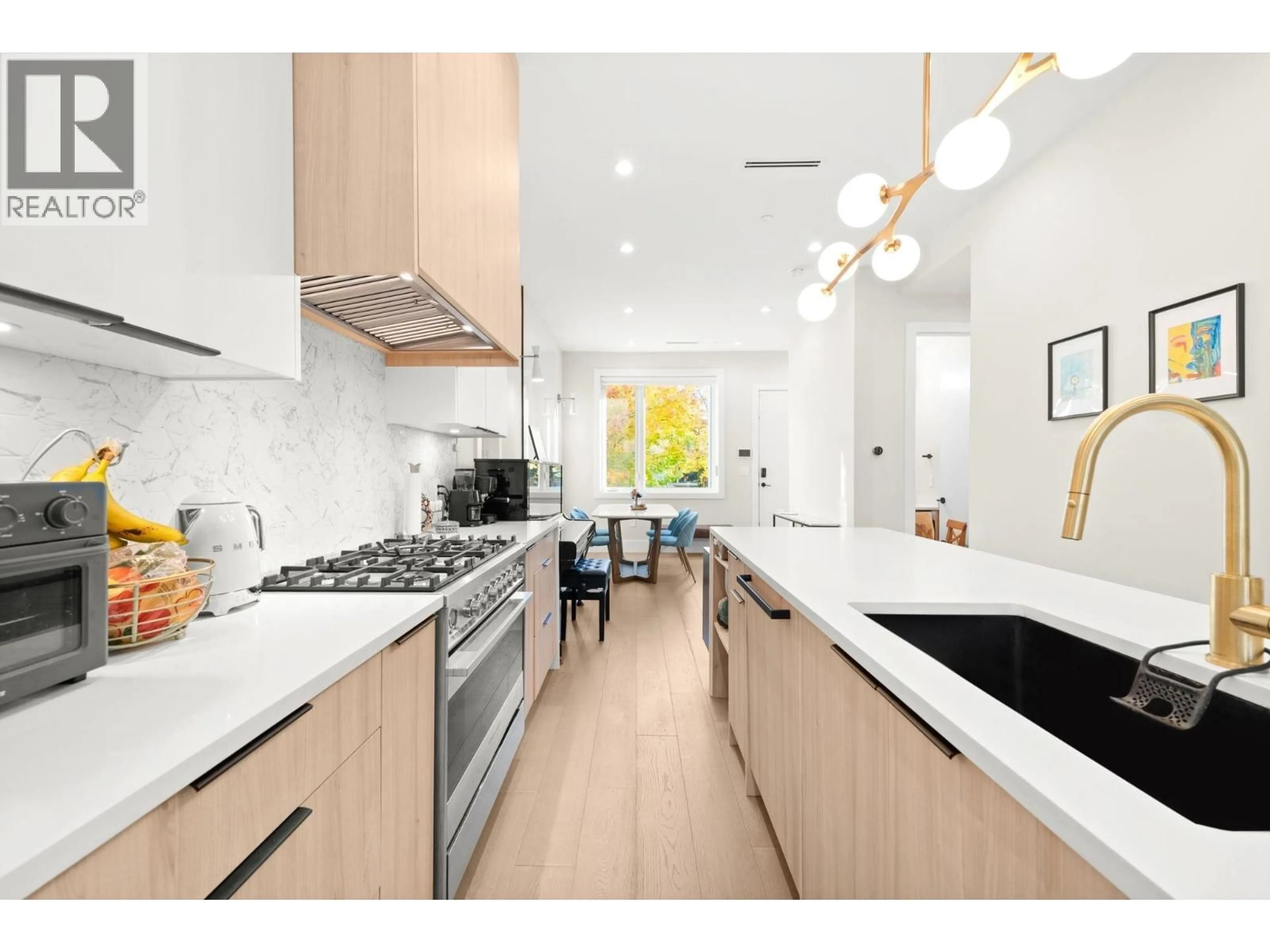 Open concept kitchen, wood/laminate floor for 2815 19TH AVENUE, Vancouver British Columbia V6L1E4