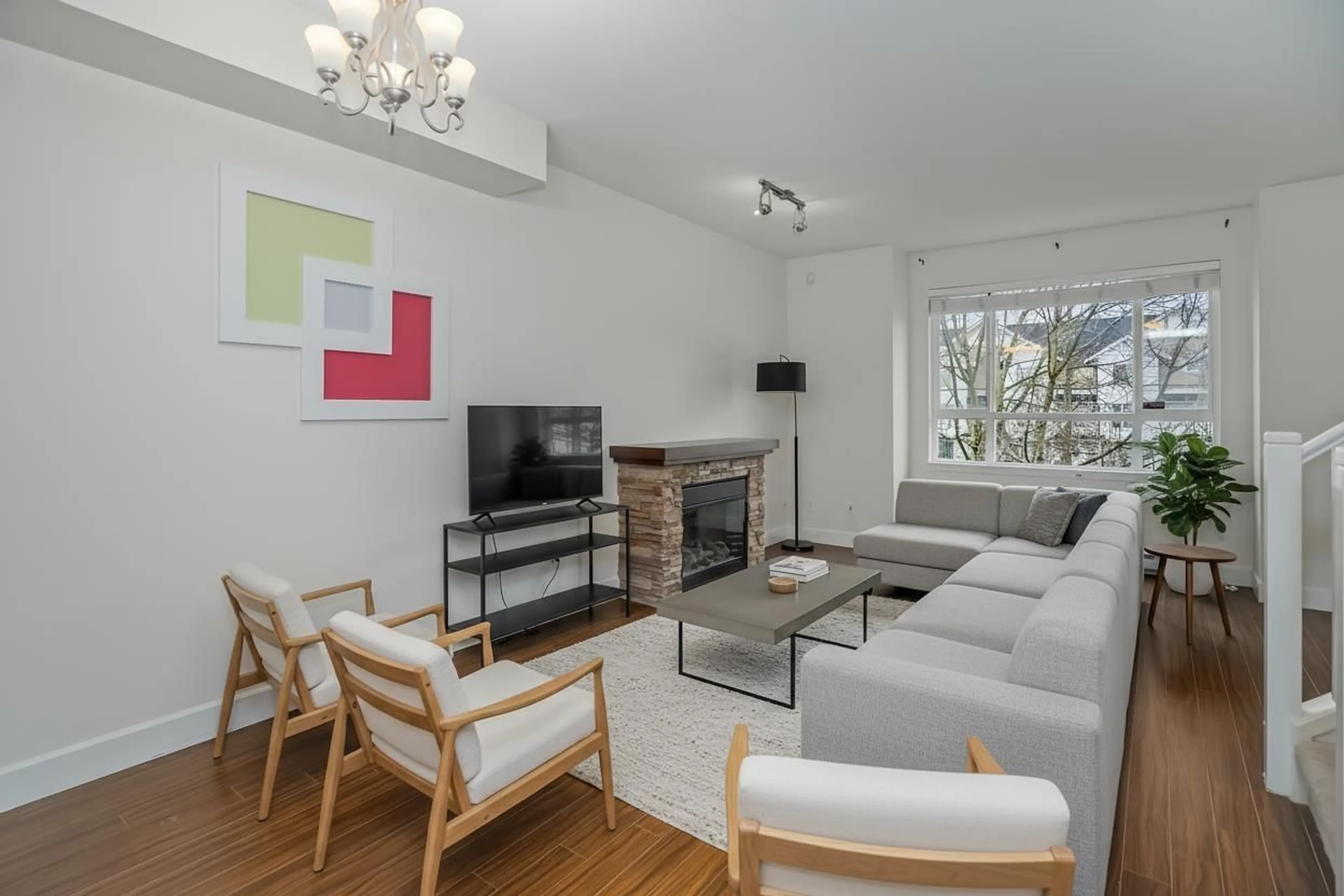 Living room with furniture, wood/laminate floor for 58 - 7088 191 STREET, Surrey British Columbia V4N0B4