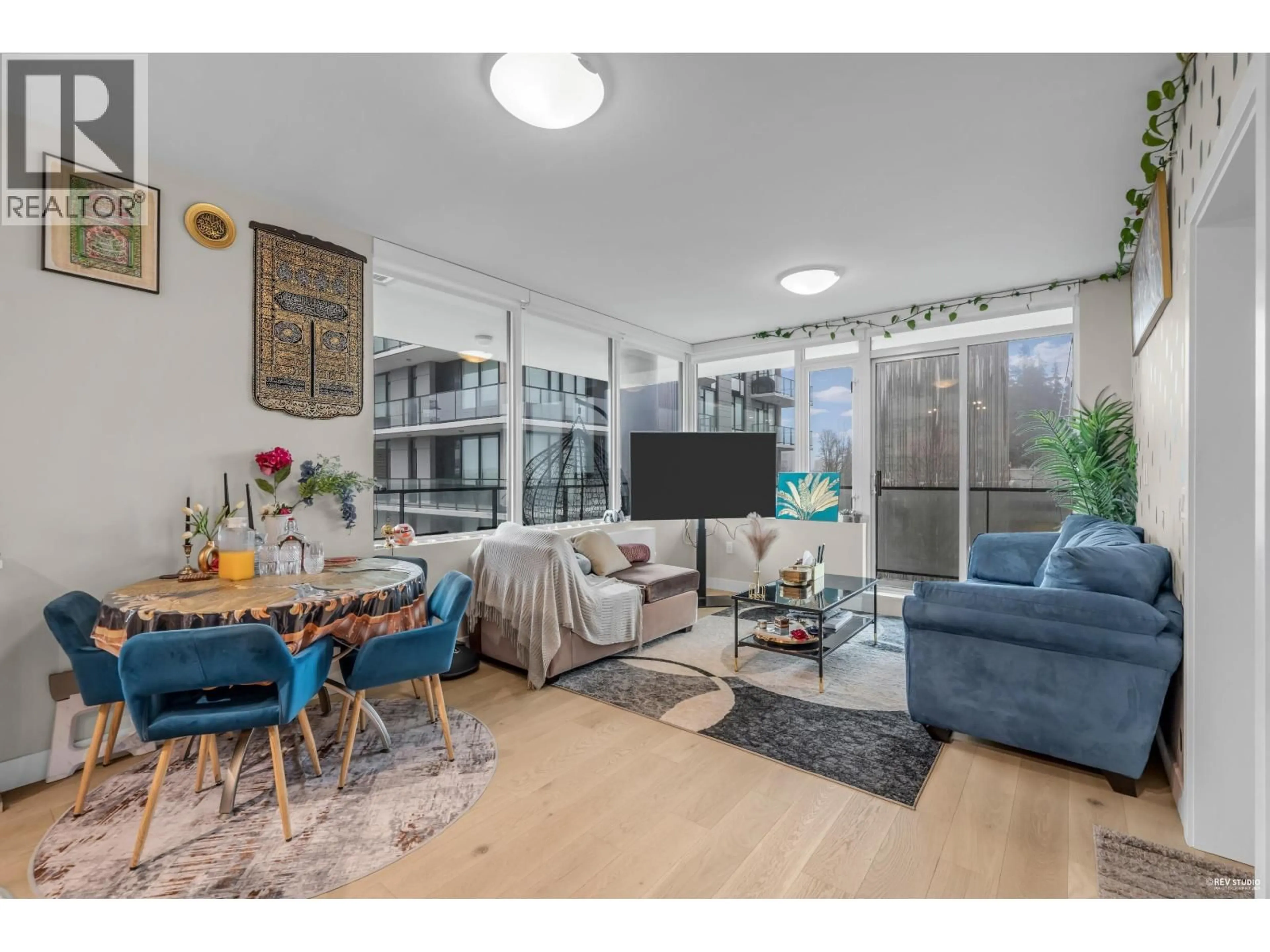 Living room with furniture, wood/laminate floor for 702 - 8725 UNIVERSITY CRESCENT, Burnaby British Columbia V5A4Y8