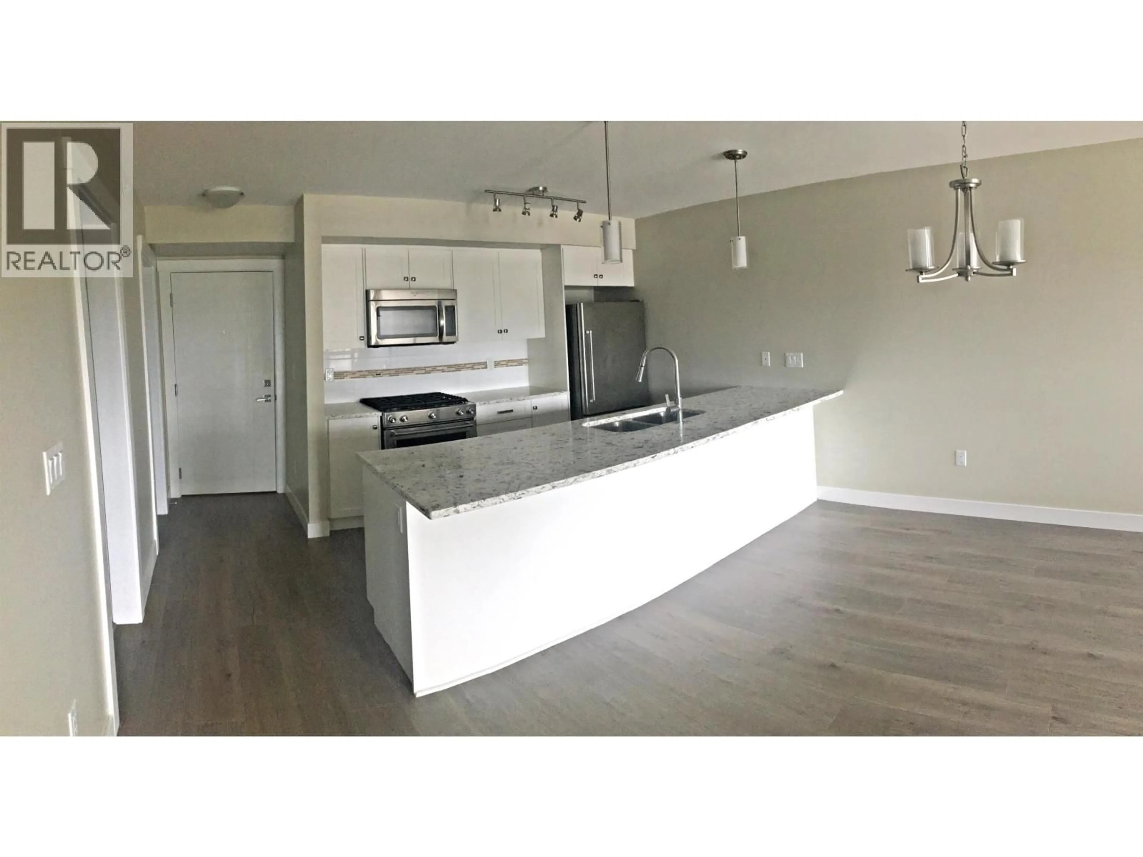 Open concept kitchen, wood/laminate floor for 302 - 4815 55B STREET, Delta British Columbia V4K3V7