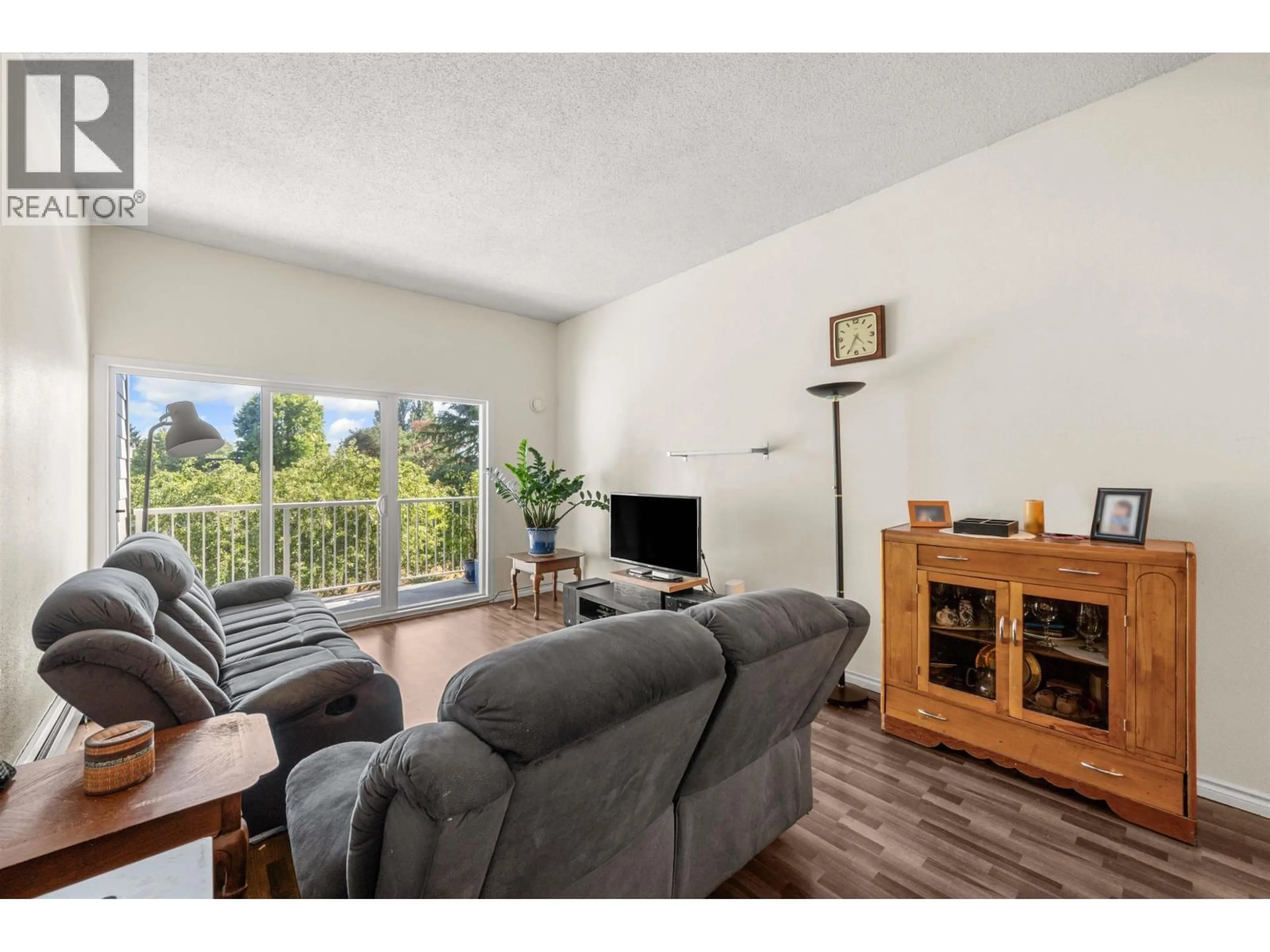 Living room with furniture, wood/laminate floor for 312 - 3451 SPRINGFIELD DRIVE, Richmond British Columbia V7E1Z2