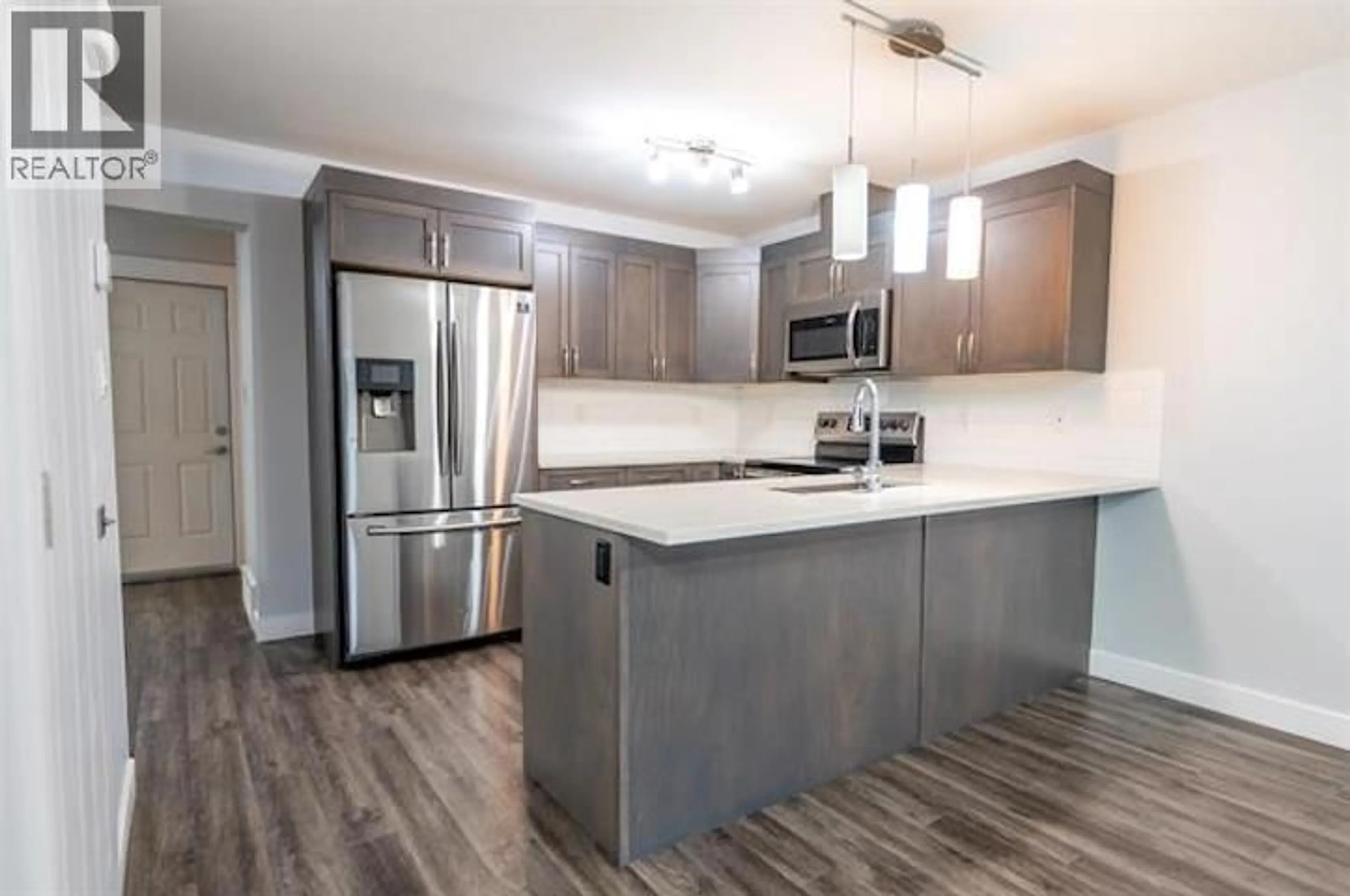 Open concept kitchen, wood/laminate floor for 302 - 6798 WESTGATE AVENUE, Prince George British Columbia V2N0H6