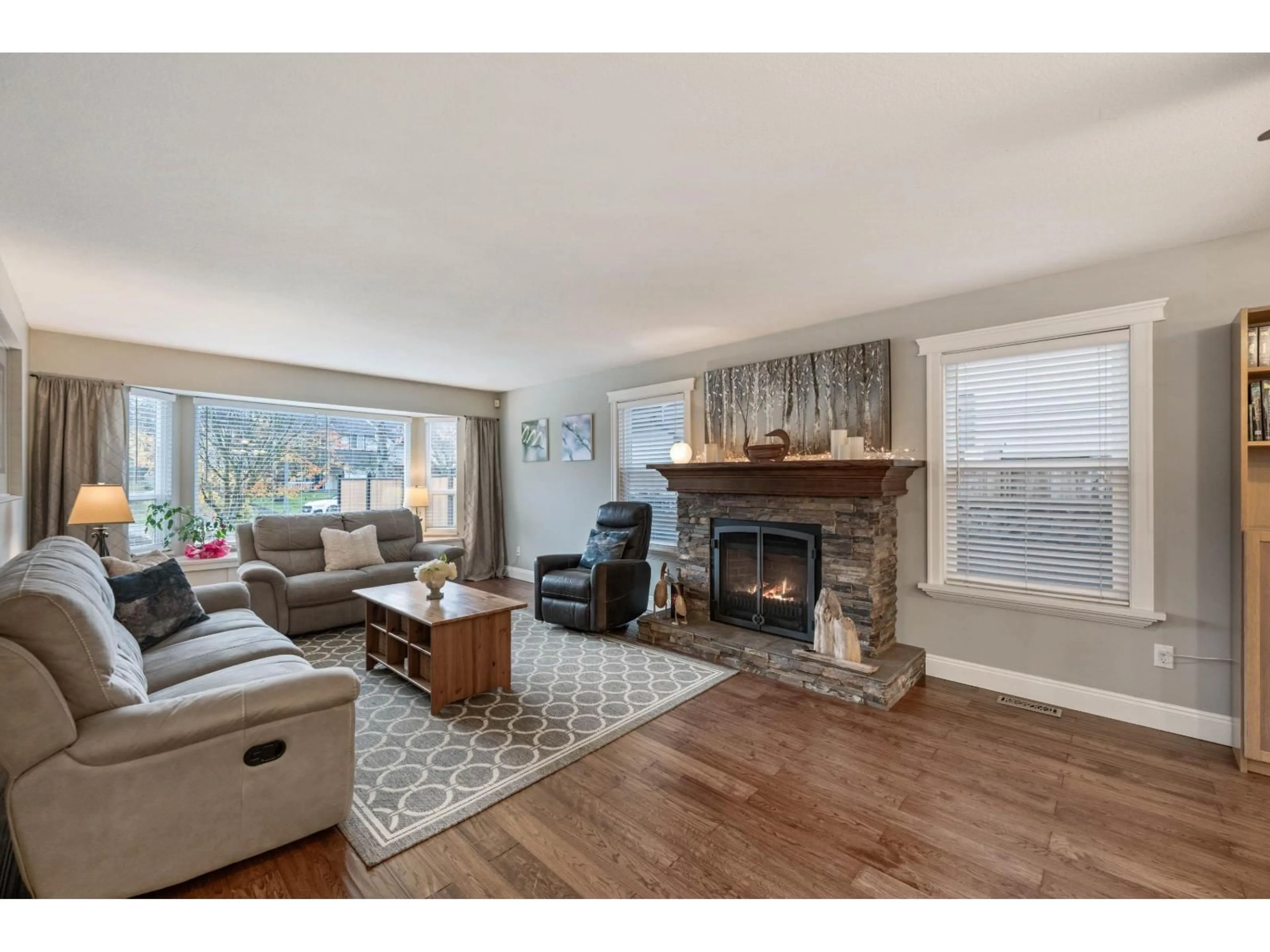 Living room with furniture, wood/laminate floor for 5259 197A STREET, Langley British Columbia V3A7Y1