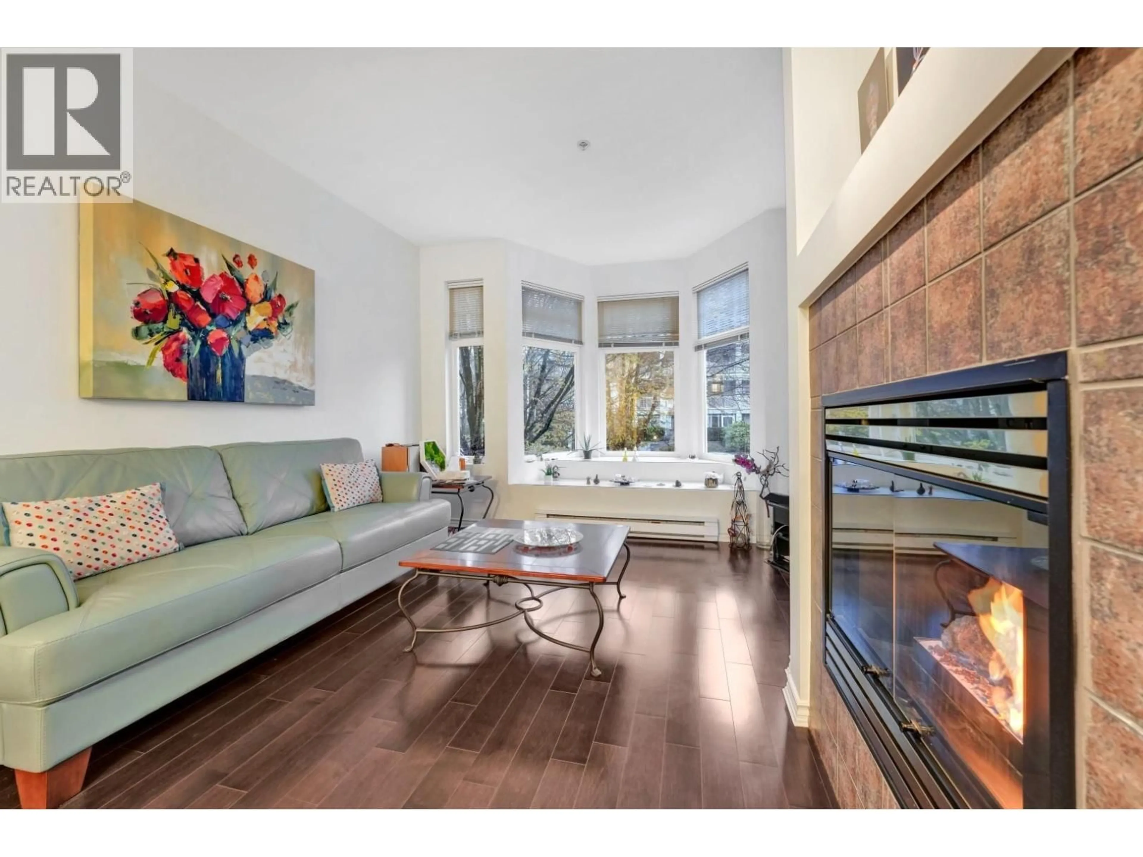 Living room with furniture, wood/laminate floor for 208 - 588 TWELFTH STREET, New Westminster British Columbia V3M4H9