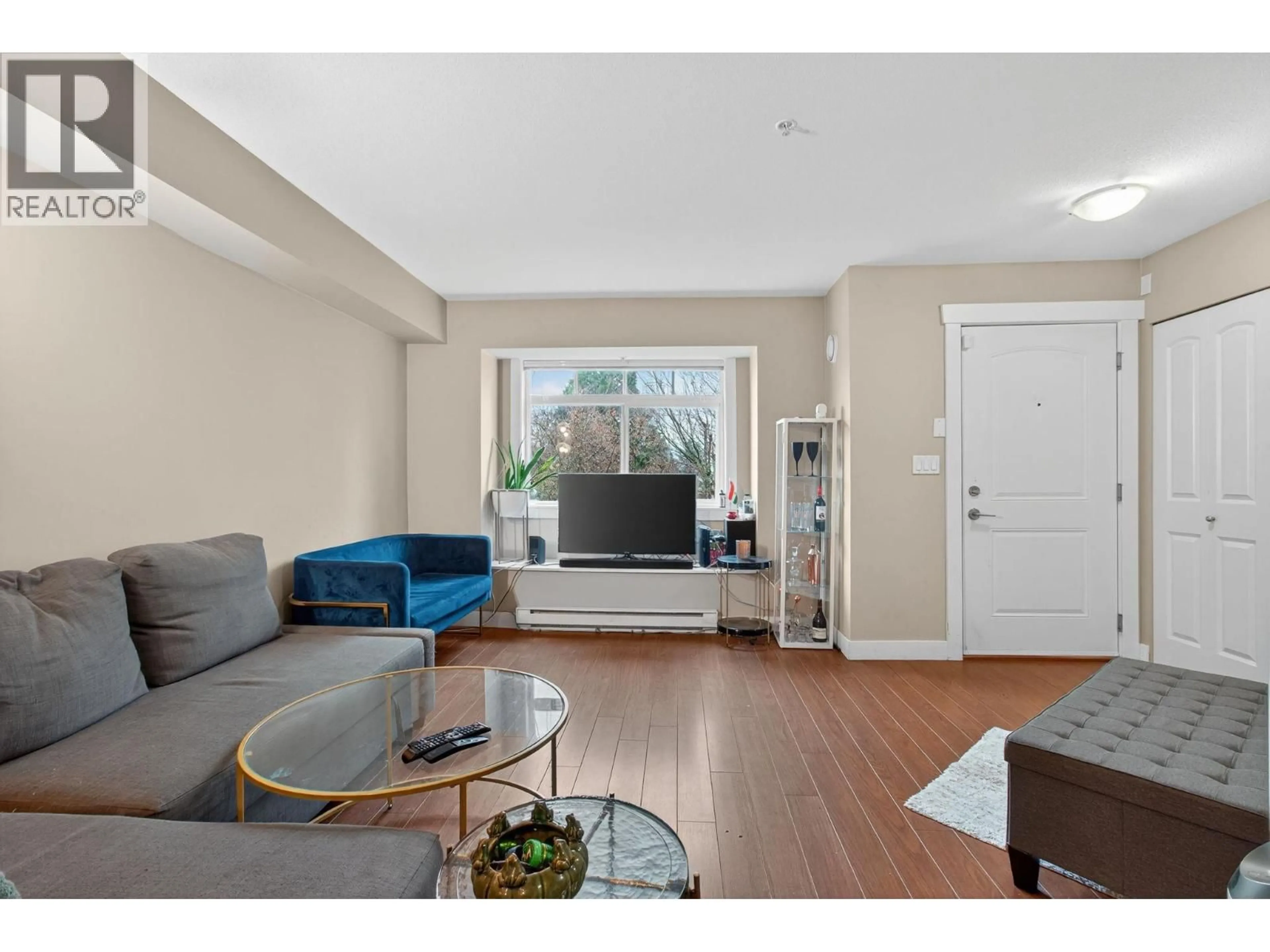 Living room with furniture, wood/laminate floor for 27 - 7428 14 AVENUE, Burnaby British Columbia V3N0C2