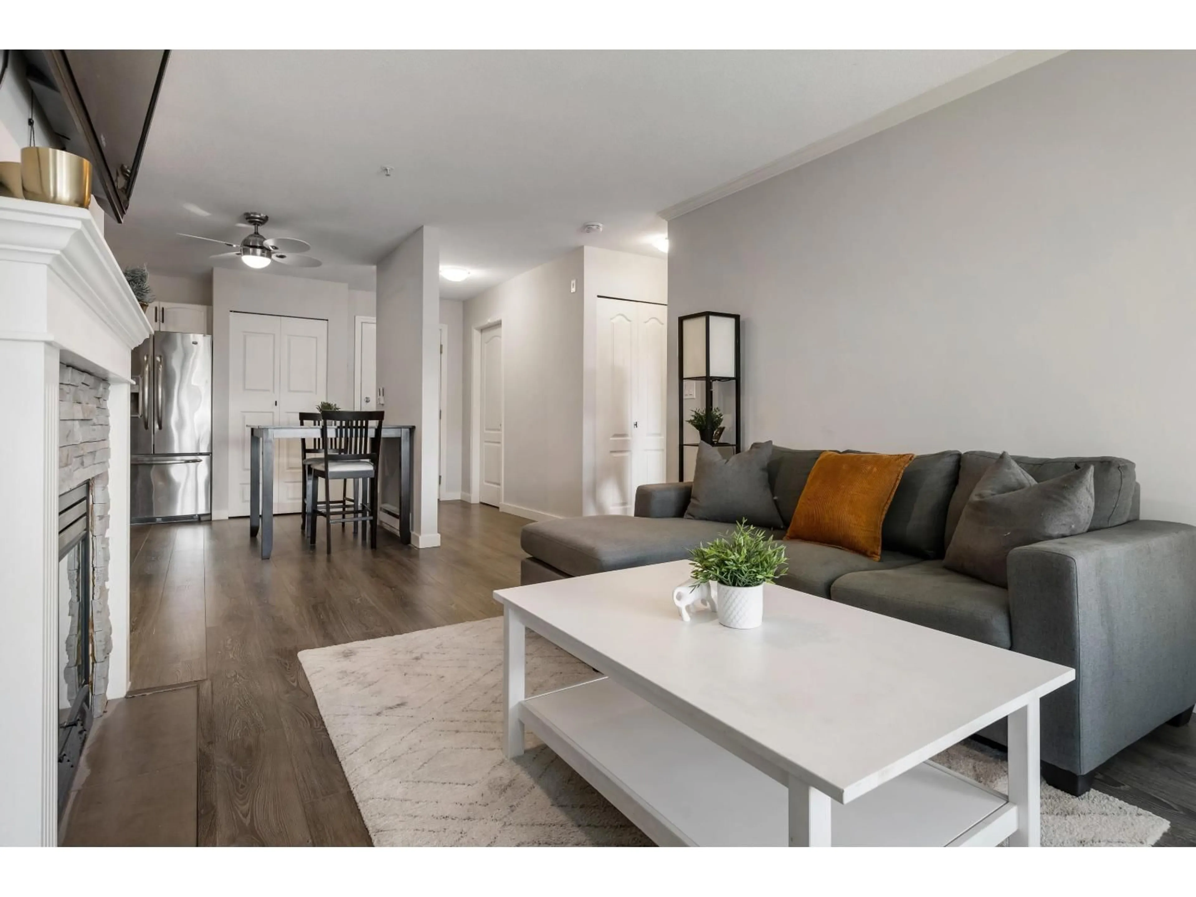 Living room with furniture, wood/laminate floor for 403 - 2958 TRETHEWEY STREET, Abbotsford British Columbia V2T6P6