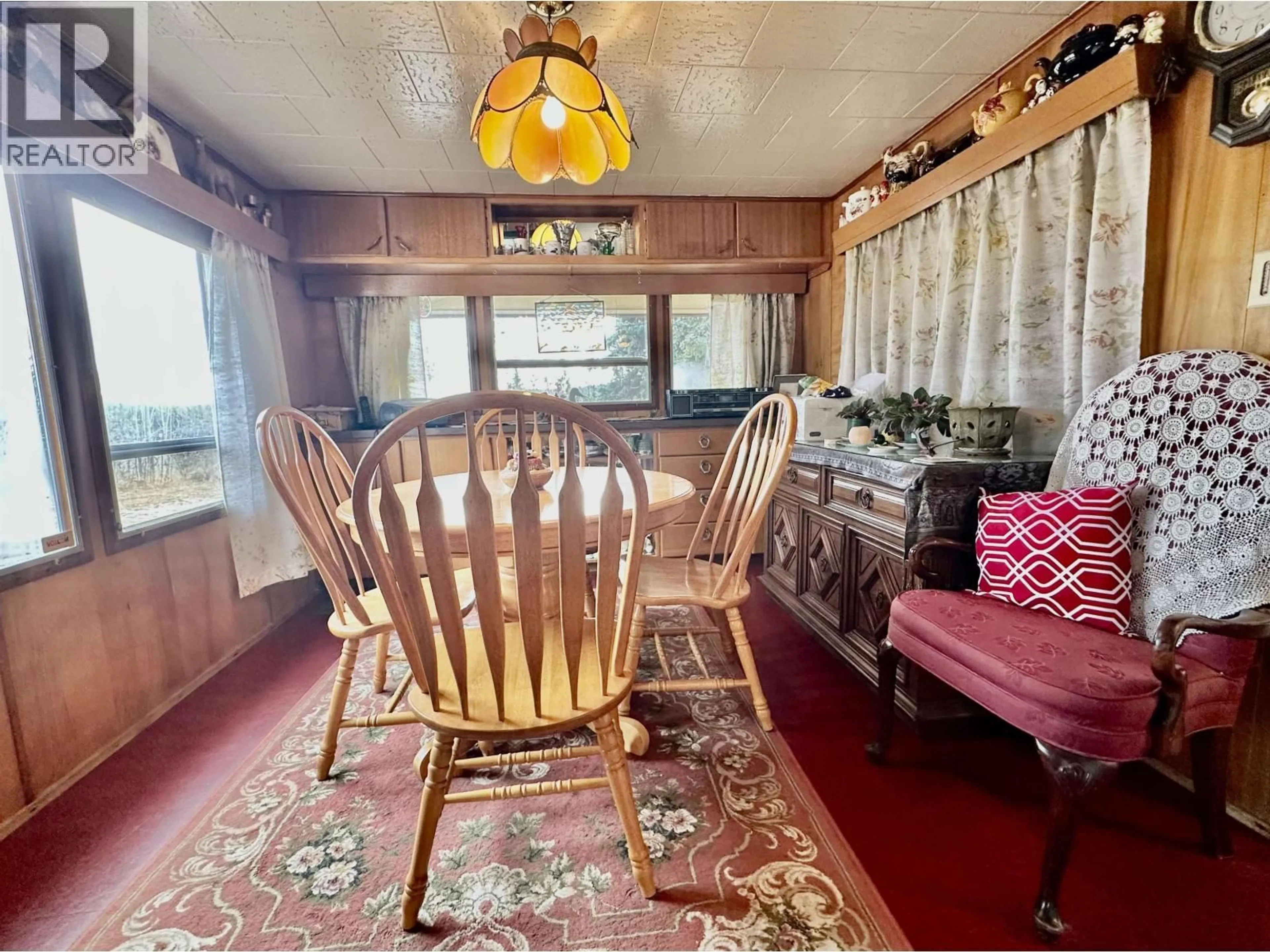 Dining room, wood/laminate floor for 6808 STOKES ROAD, 100 Mile House British Columbia V0K2E2