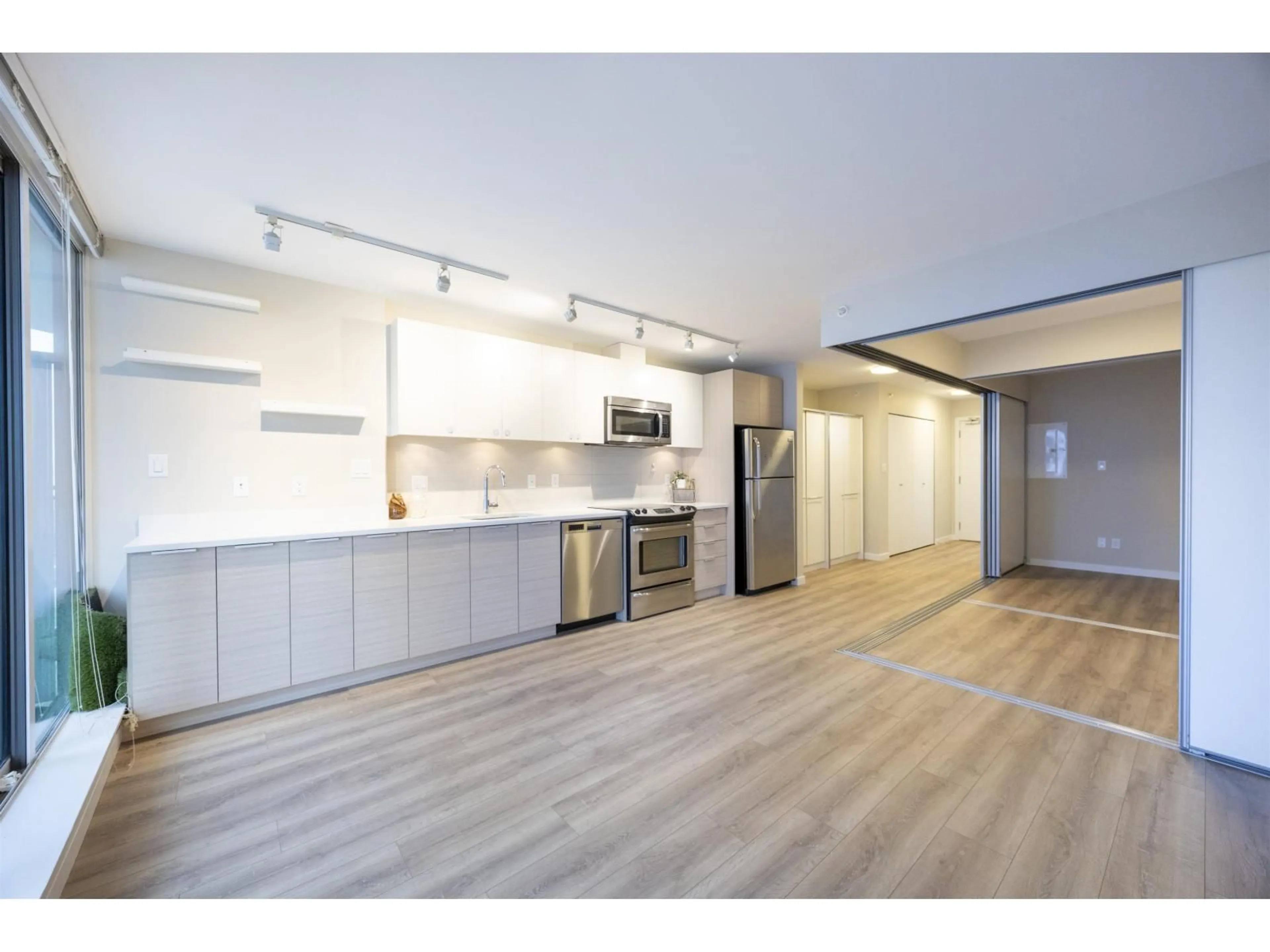 Open concept kitchen, wood/laminate floor for 2306 - 13303 CENTRAL AVENUE, Surrey British Columbia V3T0K6