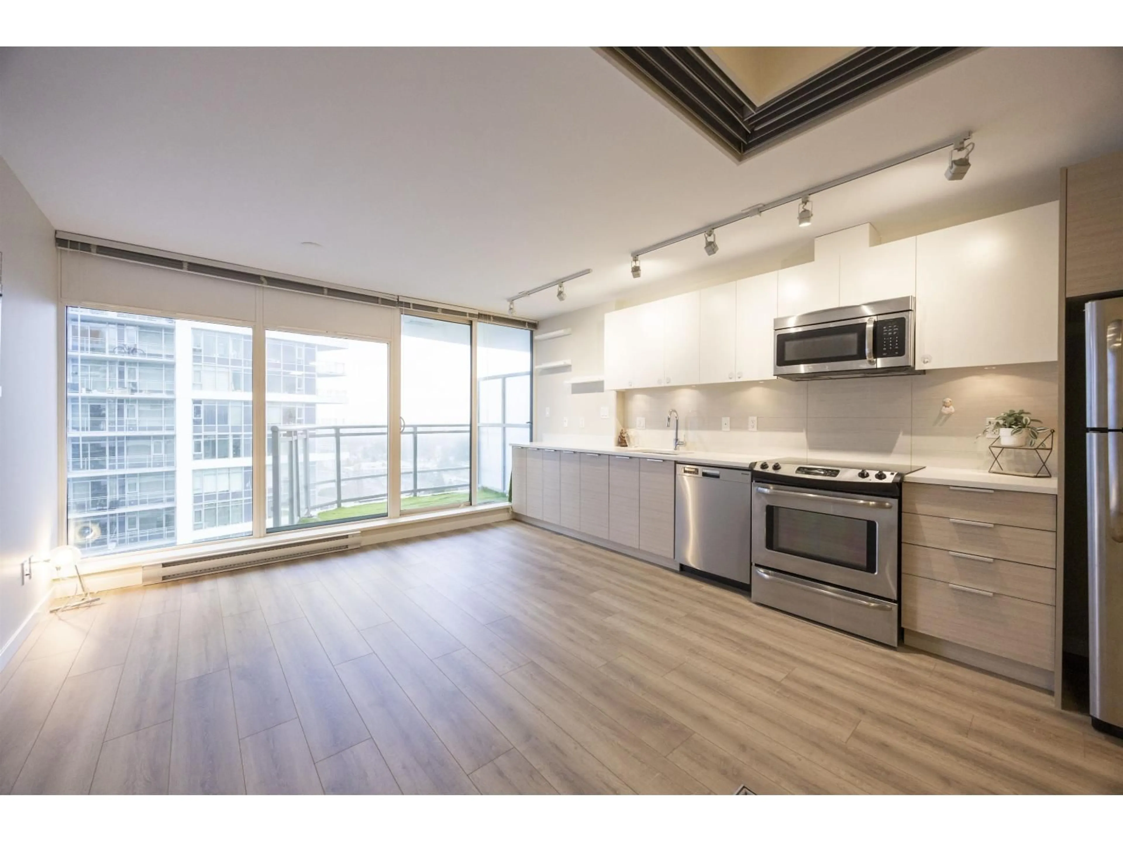 Open concept kitchen, wood/laminate floor for 2306 - 13303 CENTRAL AVENUE, Surrey British Columbia V3T0K6