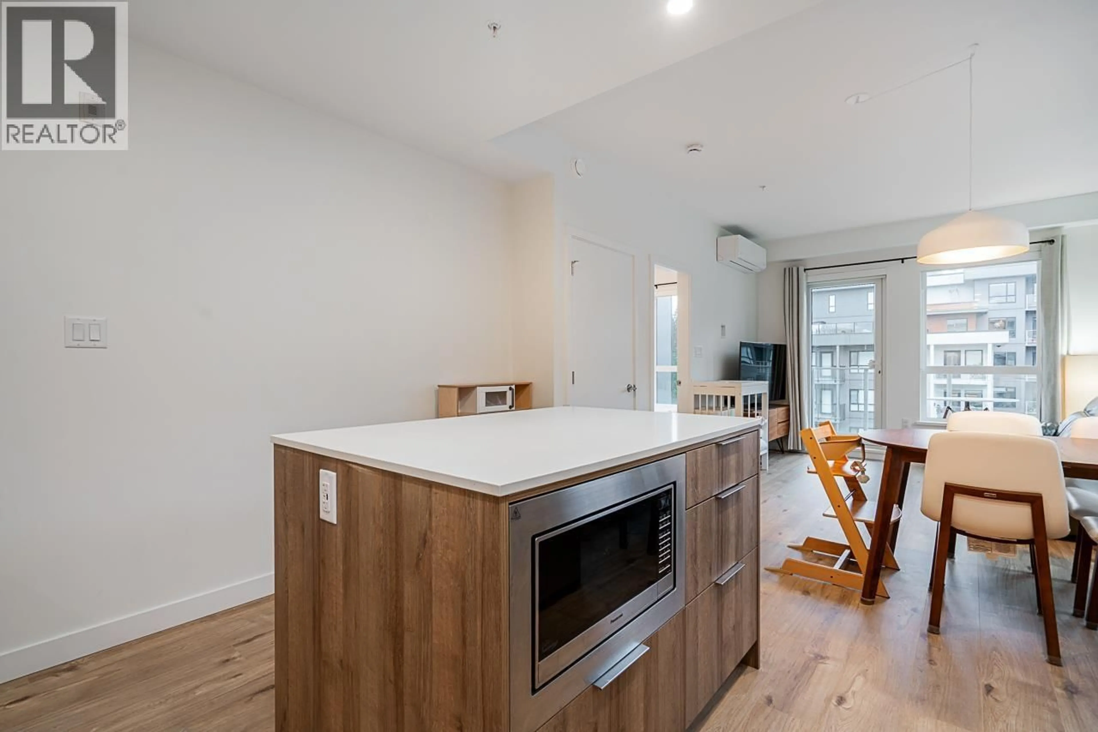 Open concept kitchen, wood/laminate floor for 422 - 3596 MALSUM DRIVE, North Vancouver British Columbia V7G0B2