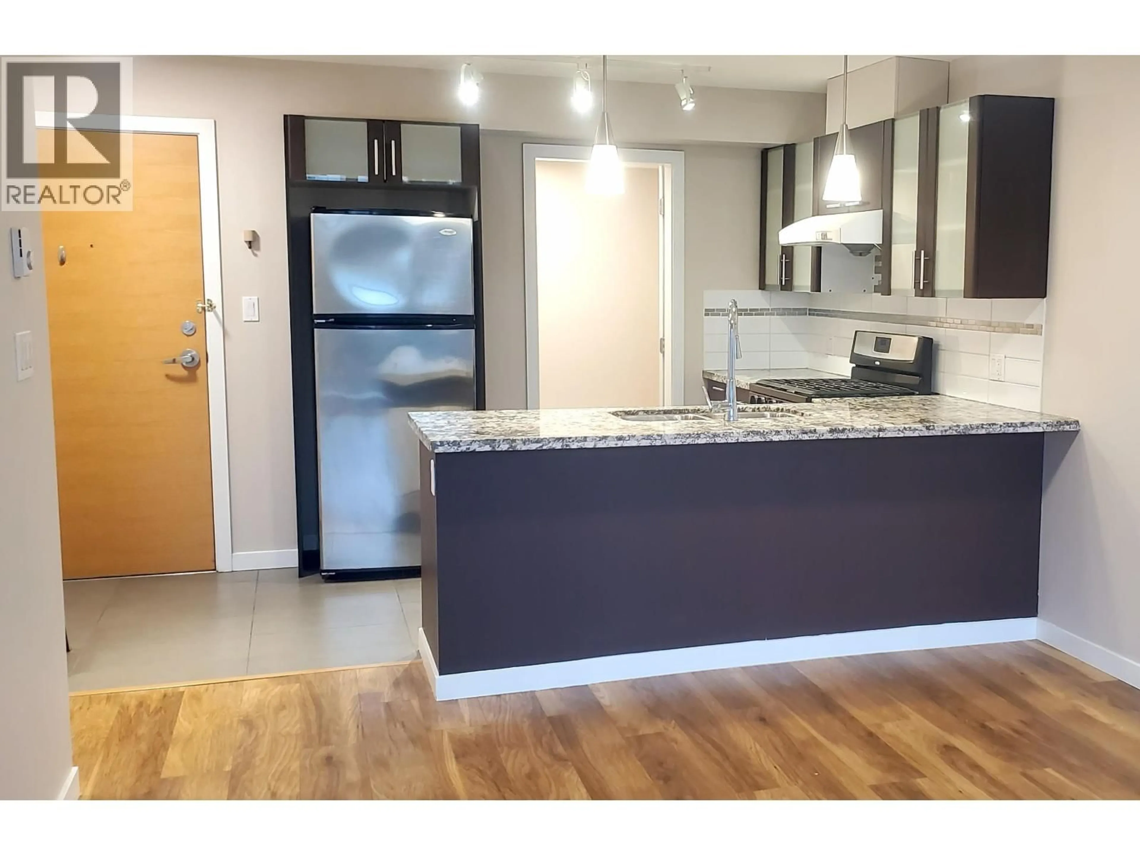 Open concept kitchen, wood/laminate floor for 607 - 7888 SABA ROAD, Richmond British Columbia V6Y0A2