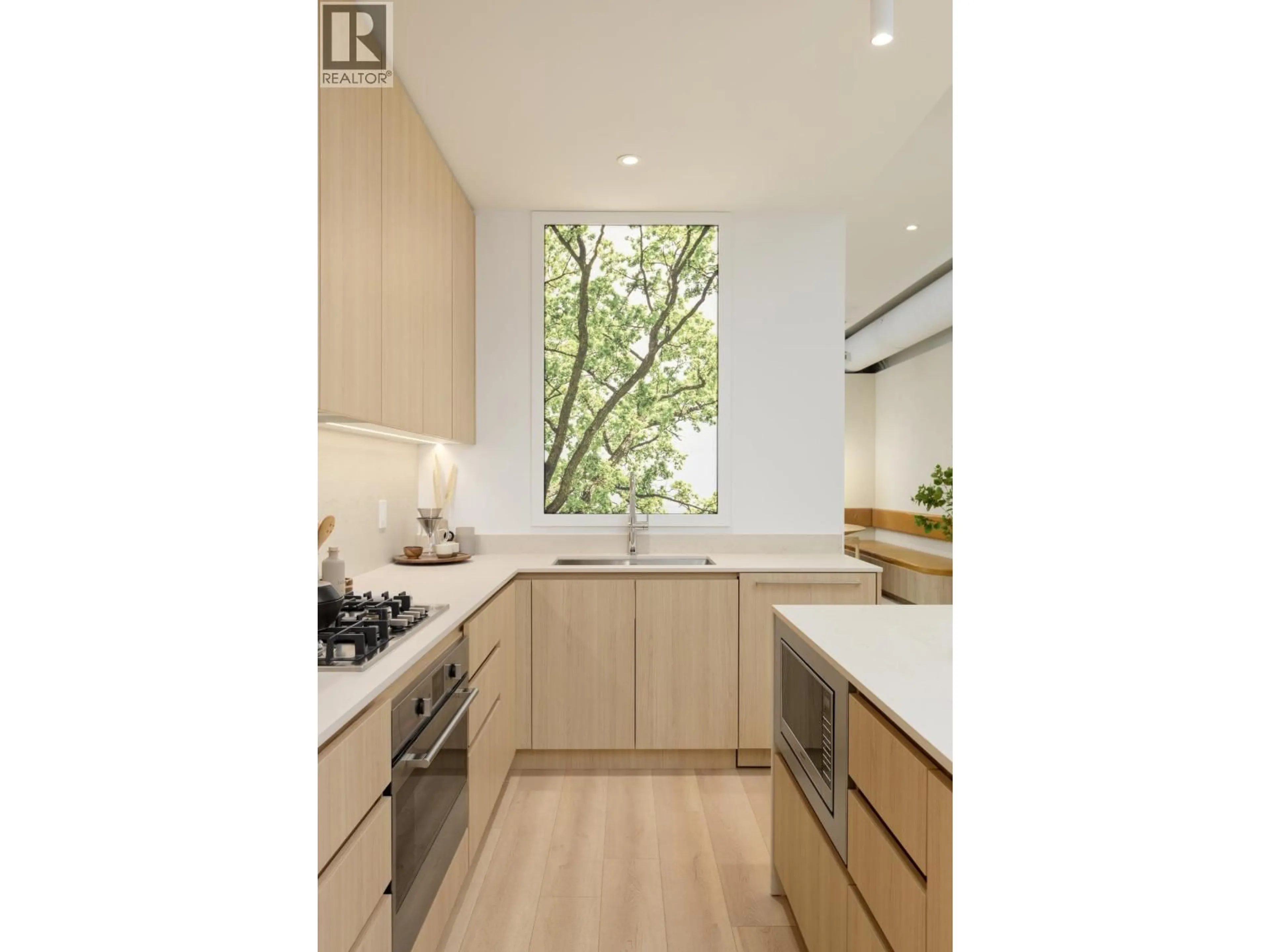 Contemporary kitchen, wood/laminate floor for 104 - 2810 NANAIMO STREET, Vancouver British Columbia V5M2E1