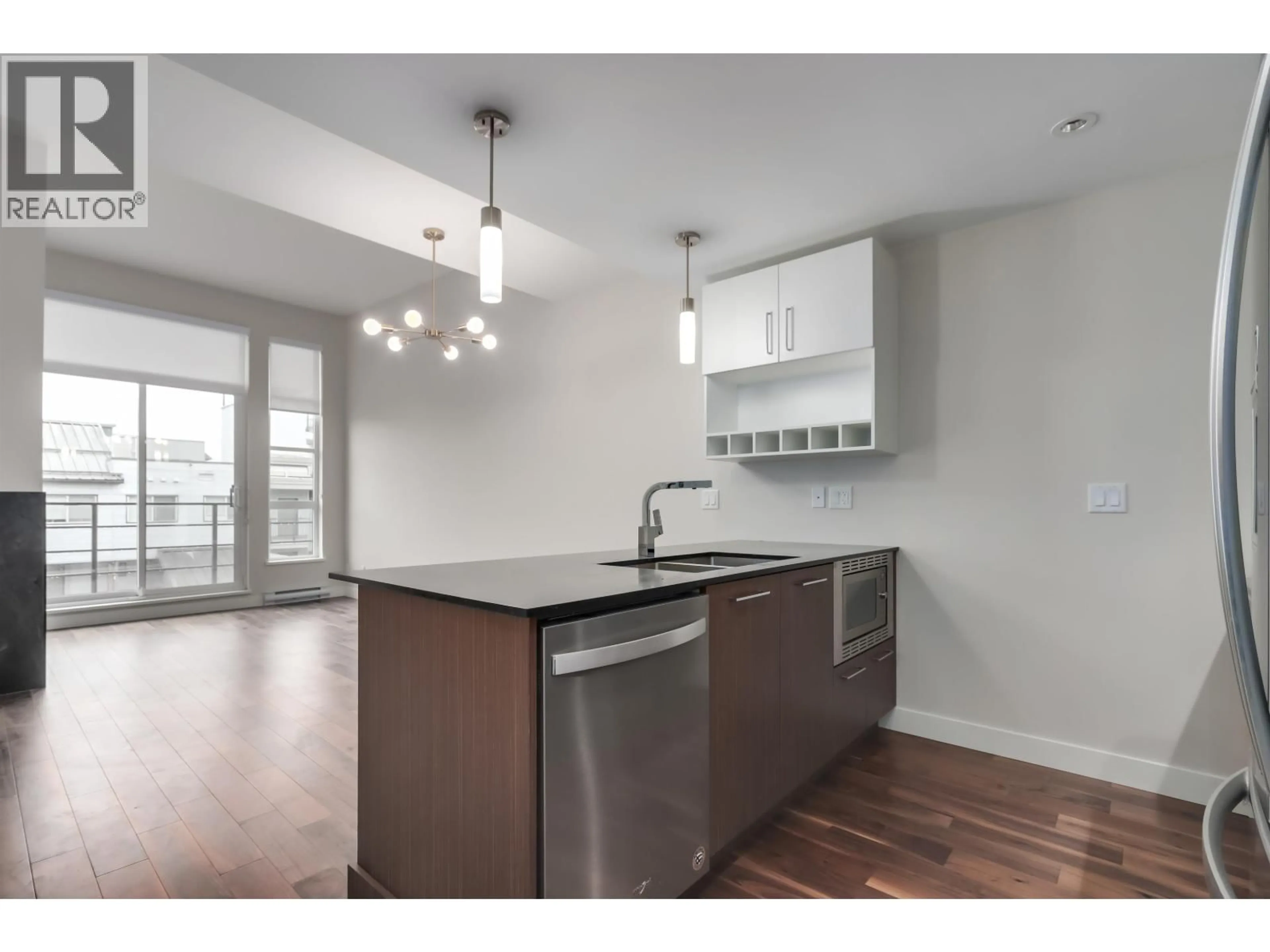 Open concept kitchen, wood/laminate floor for 411 - 13040 NO. 2 ROAD, Richmond British Columbia V7E0C4
