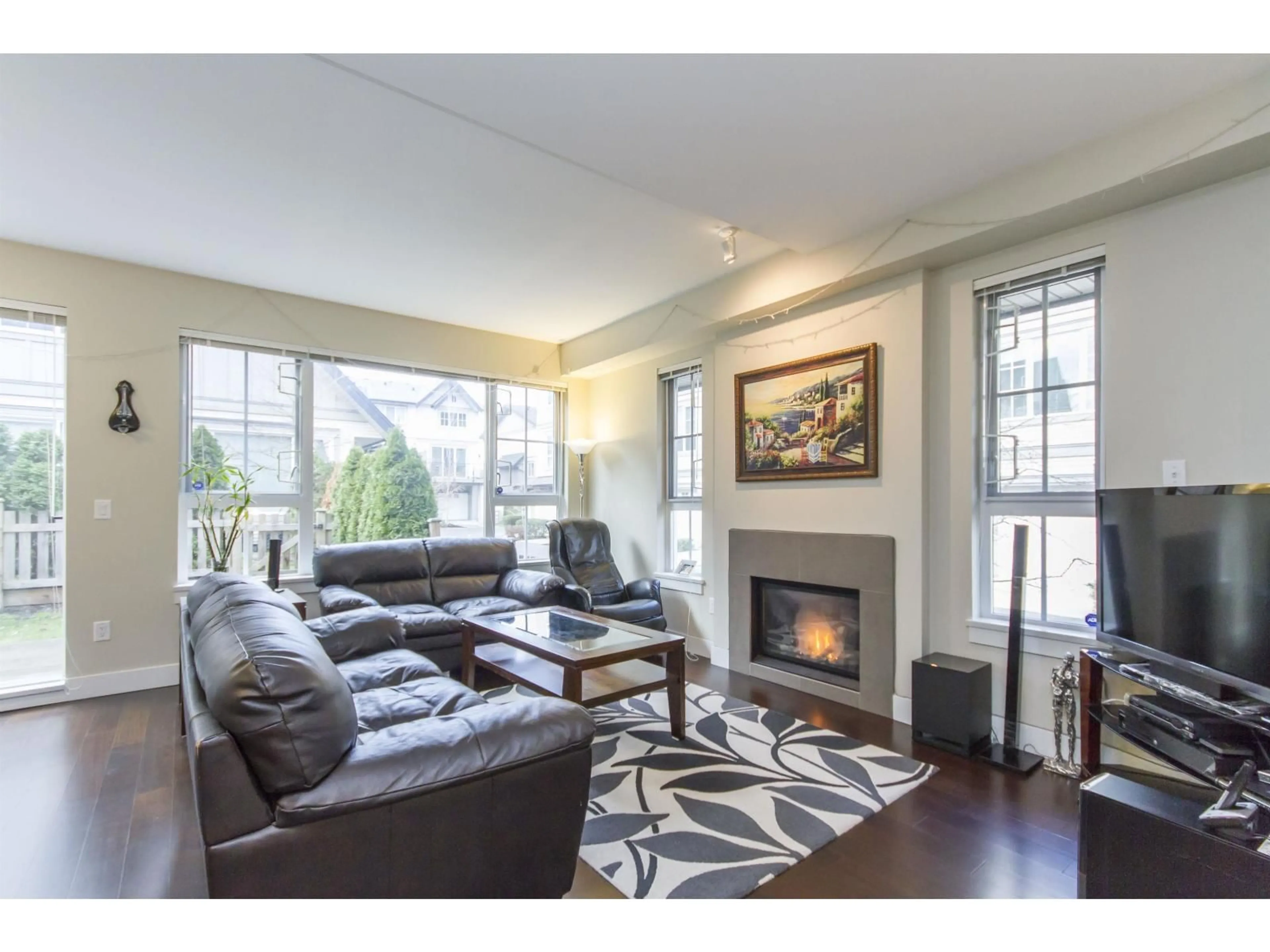 Living room with furniture, wood/laminate floor for 203 - 2501 161 A STREET, Surrey British Columbia V3Z7Y6