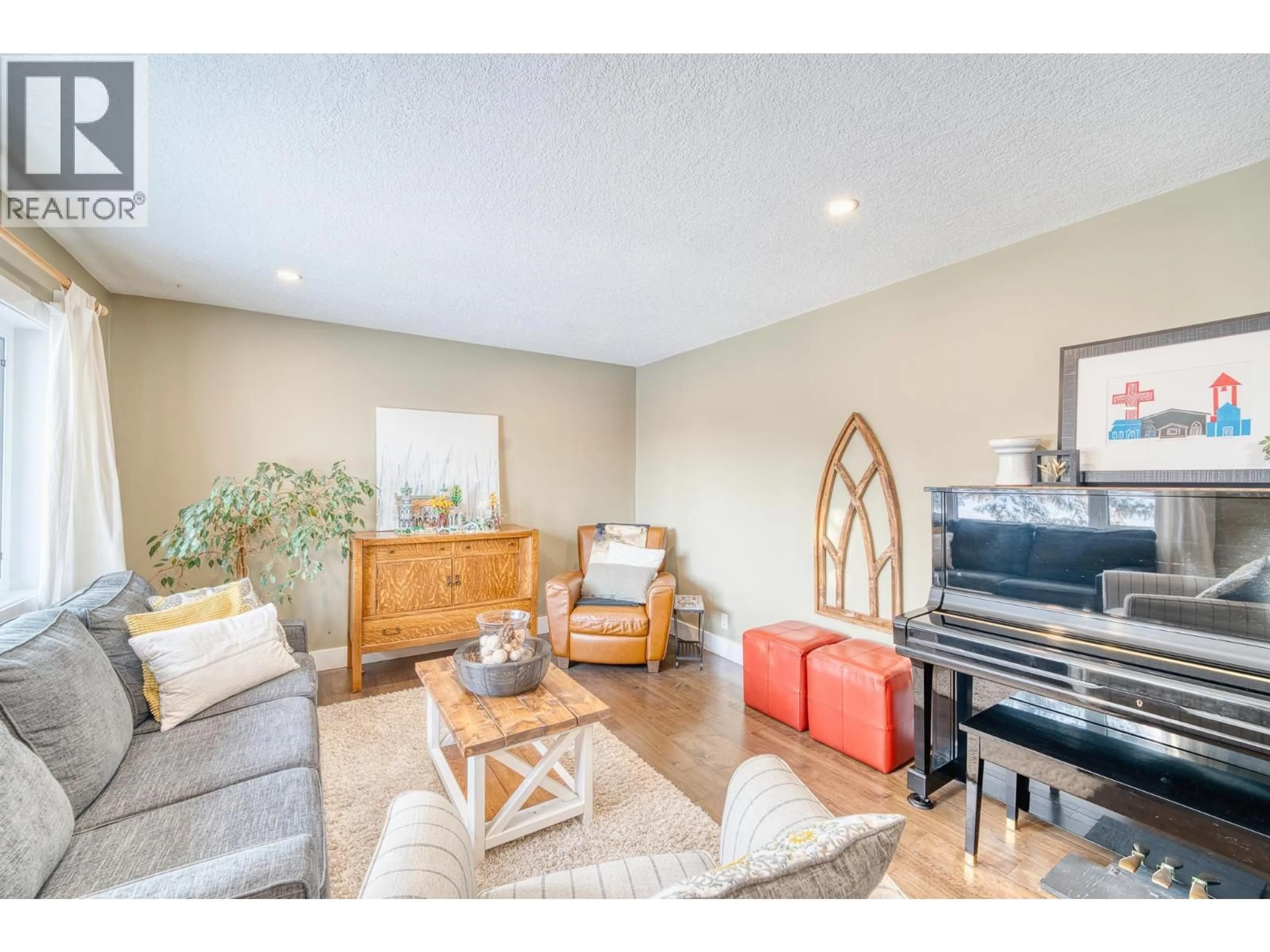 Living room with furniture, wood/laminate floor for 9612 105 AVENUE, Fort St. John British Columbia V1J2M1