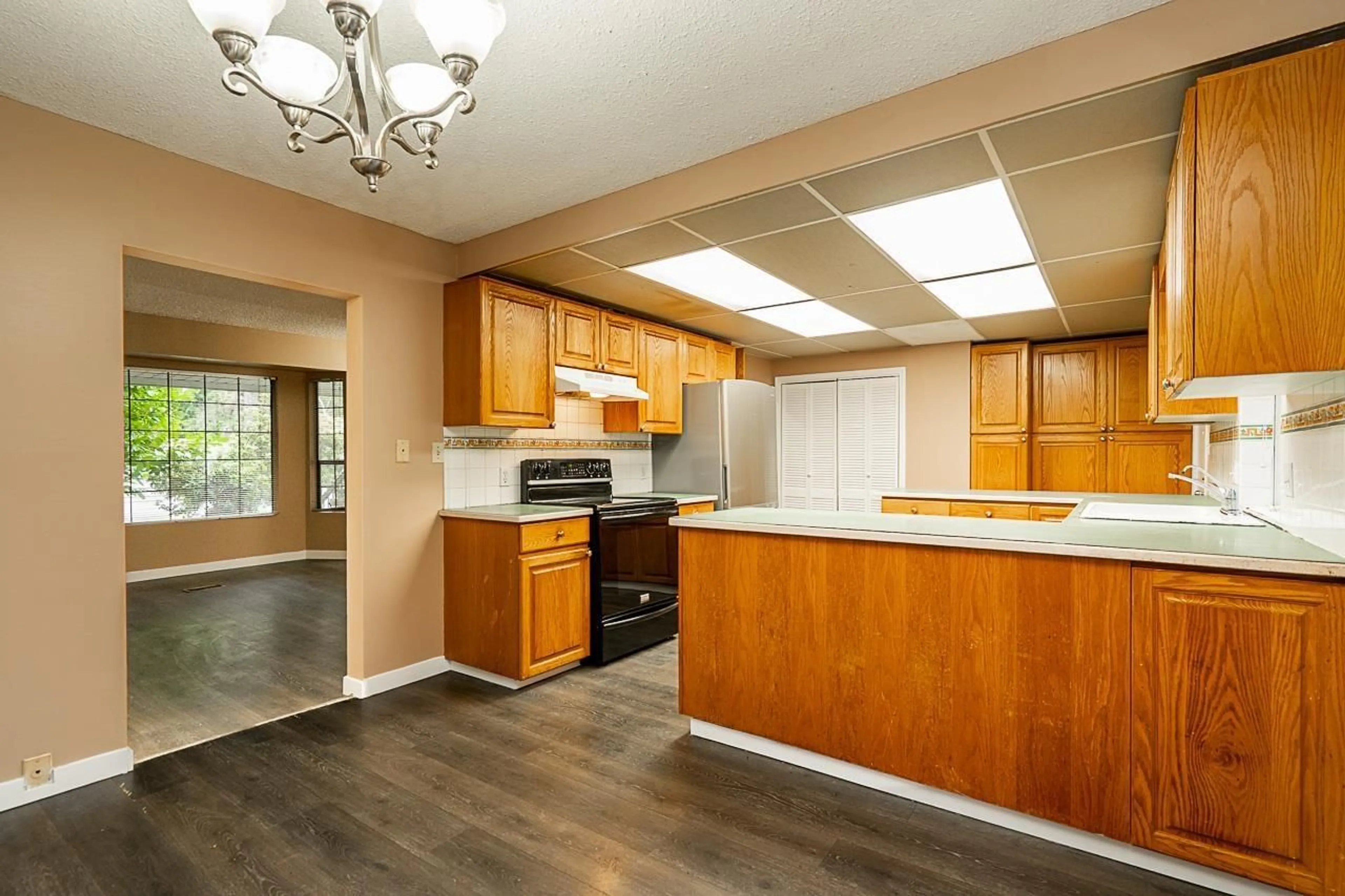 Open concept kitchen, wood/laminate floor for 14720 60 AVENUE, Surrey British Columbia V3S1R7