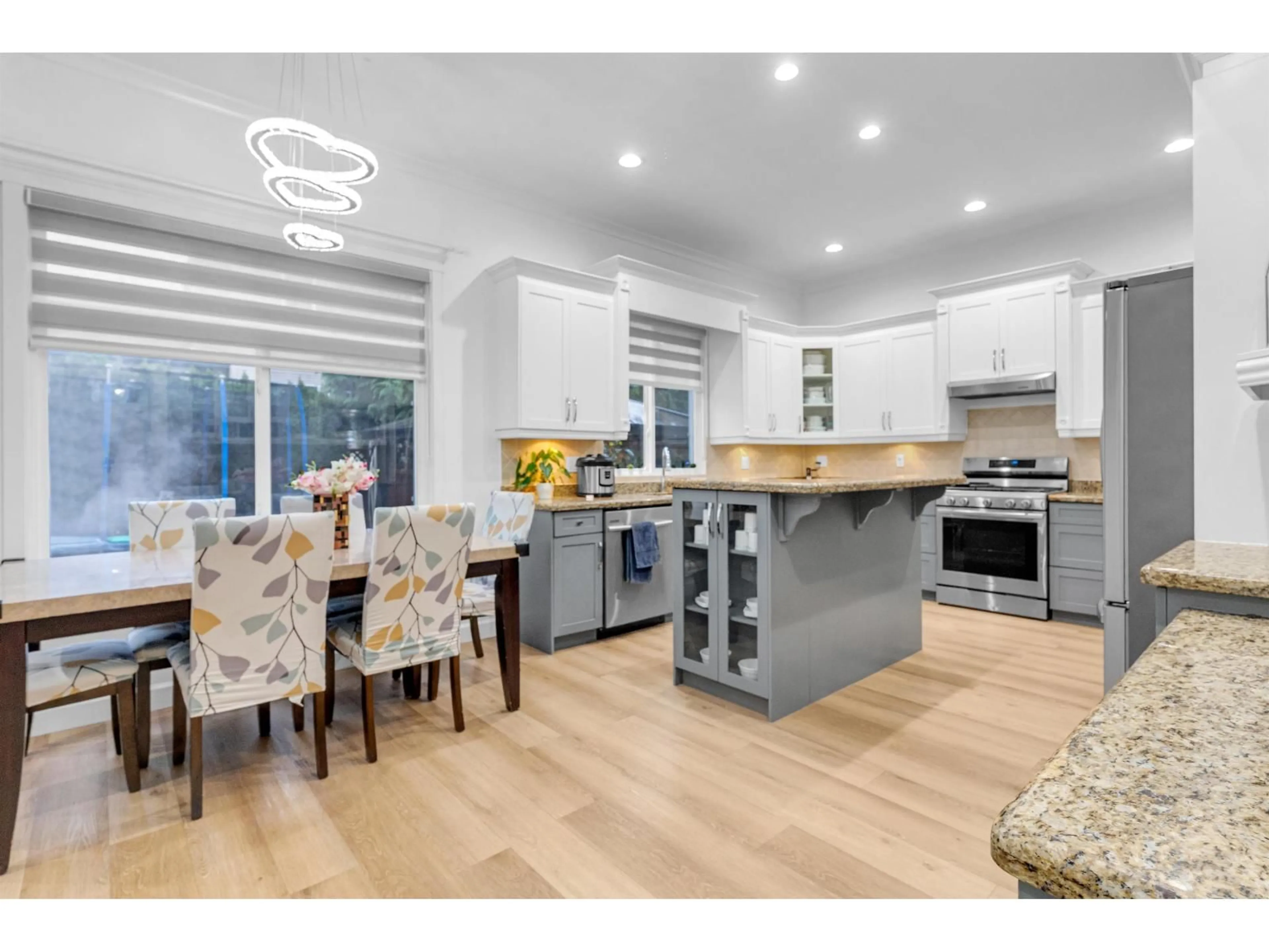 Open concept kitchen, wood/laminate floor for 18358 67 AVENUE, Surrey British Columbia V3S1E5