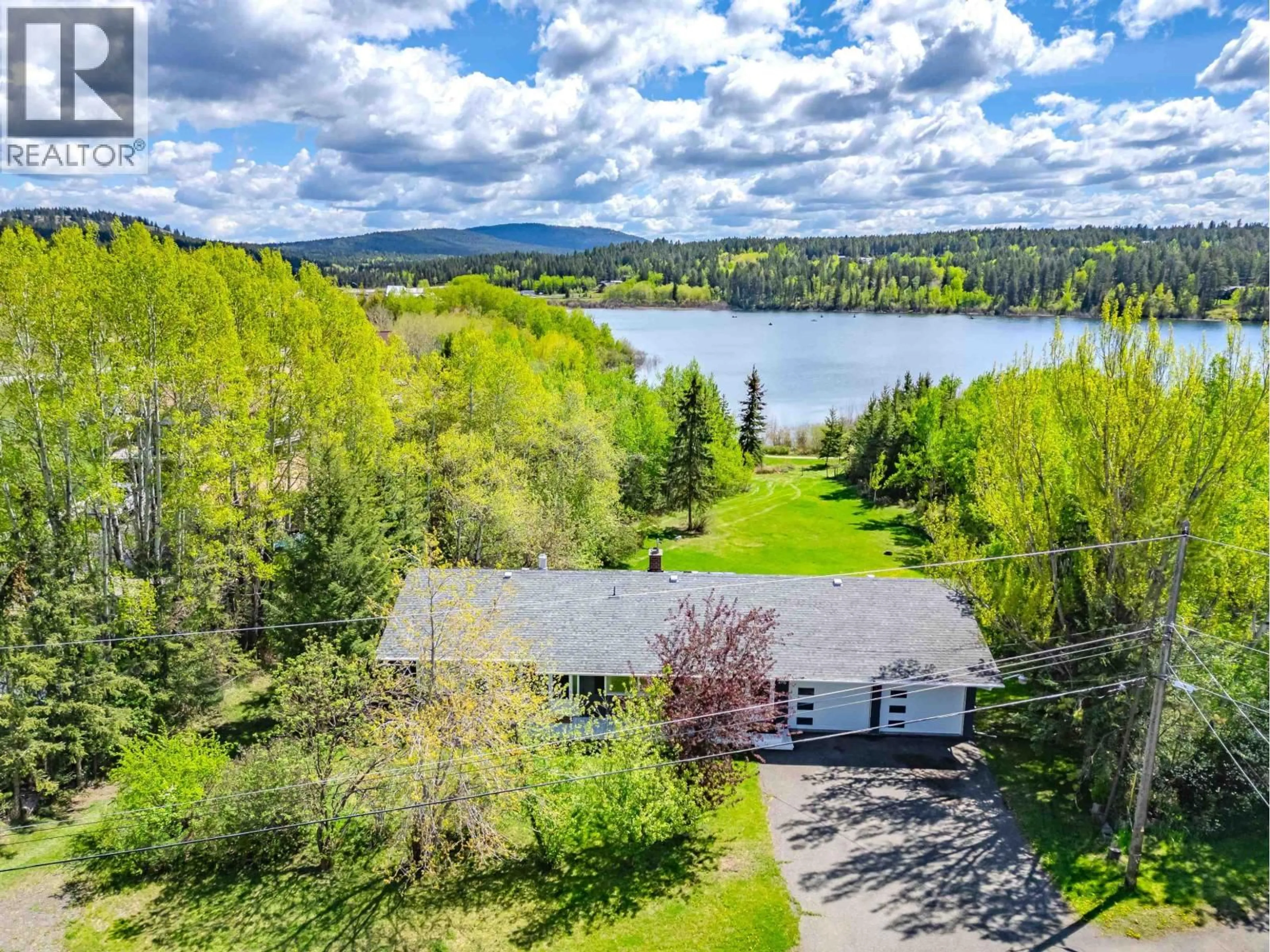 A pic from outside/outdoor area/front of a property/back of a property/a pic from drone, water/lake/river/ocean view for 4715 PARKER COURT, 108 Mile Ranch British Columbia V0K2Z0