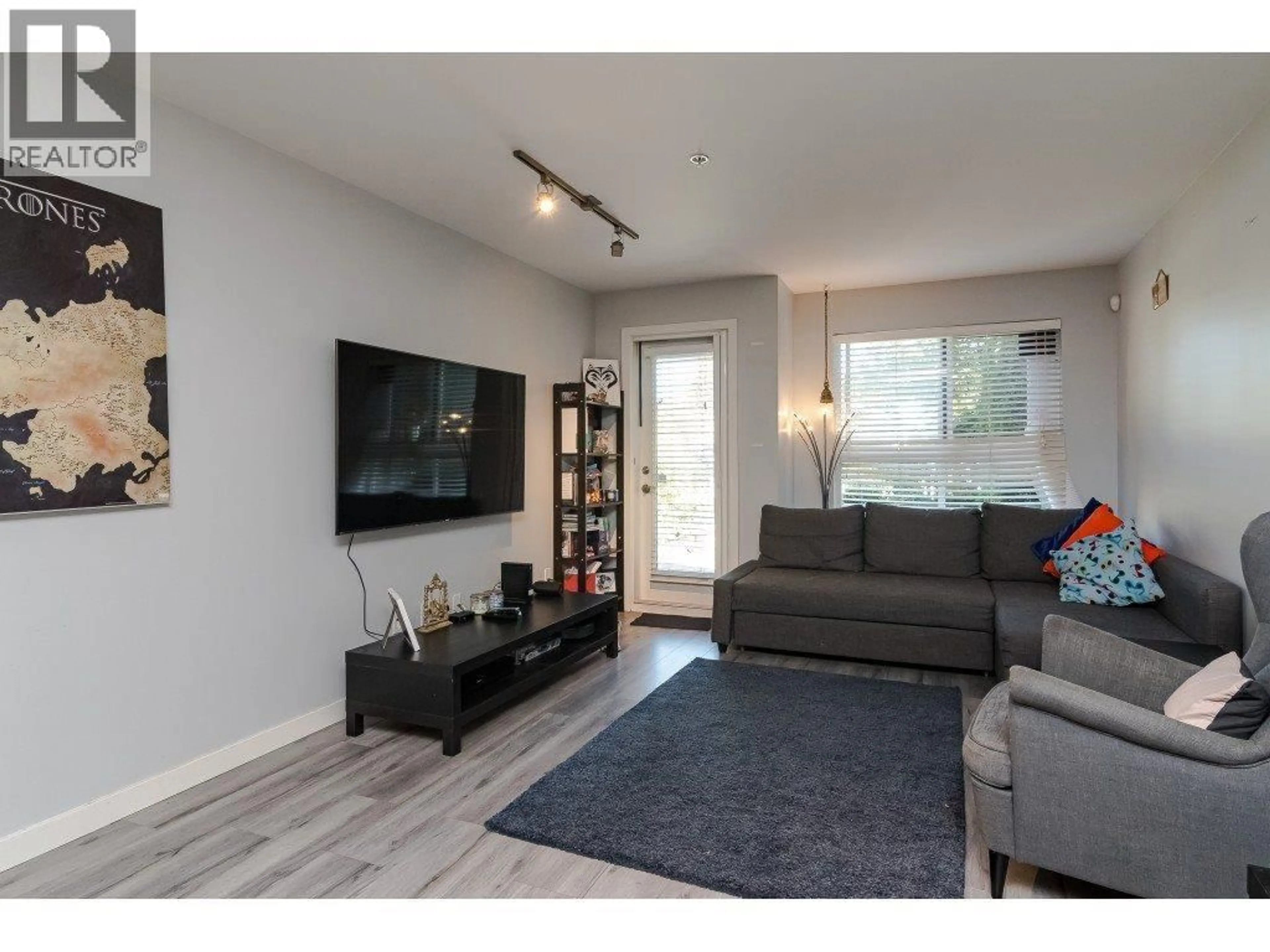 Living room with furniture, wood/laminate floor for 103 - 2191 SHAUGHNESSY STREET, Port Coquitlam British Columbia V3C3C7