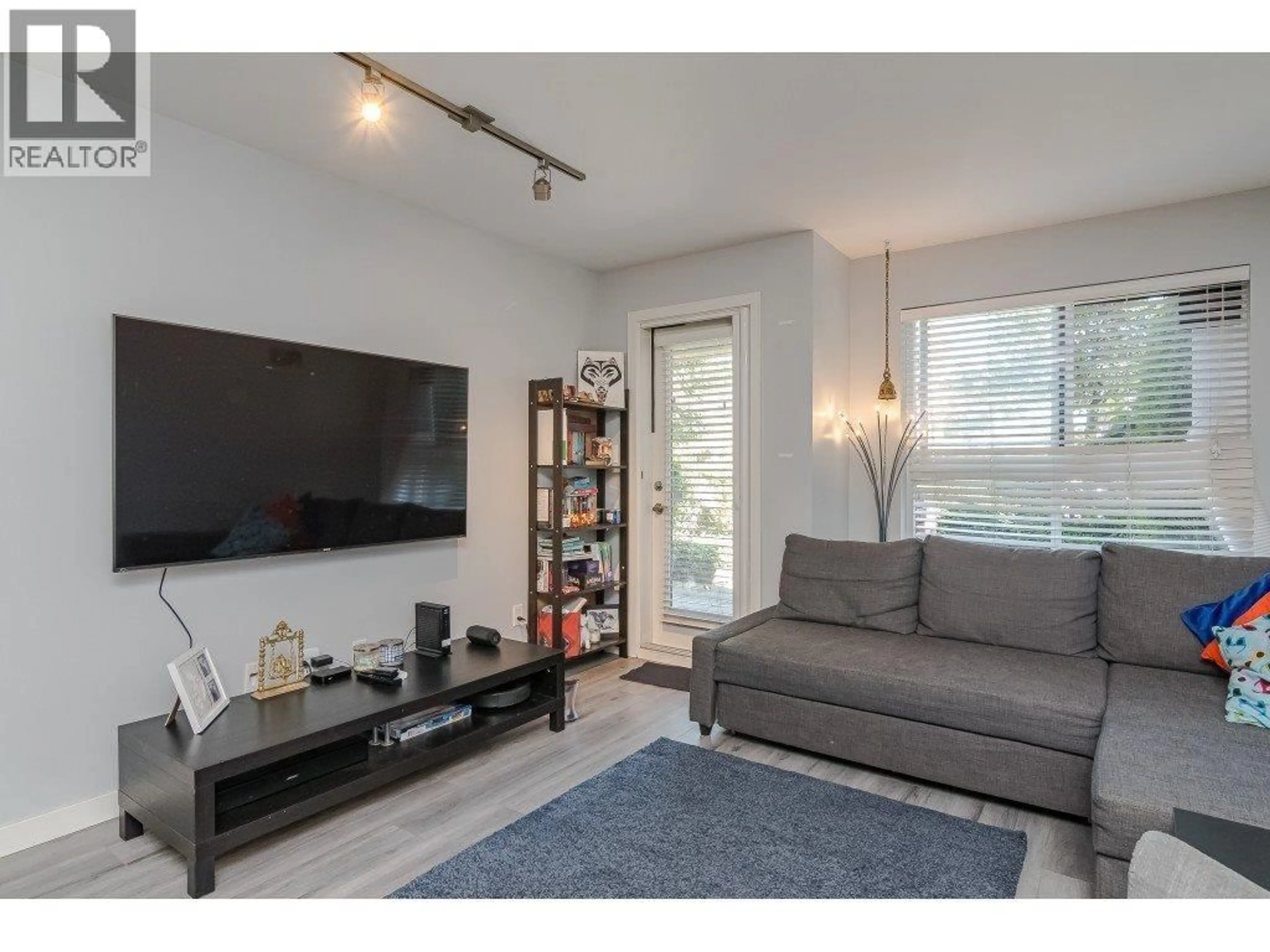 Living room with furniture, wood/laminate floor for 103 - 2191 SHAUGHNESSY STREET, Port Coquitlam British Columbia V3C3C7
