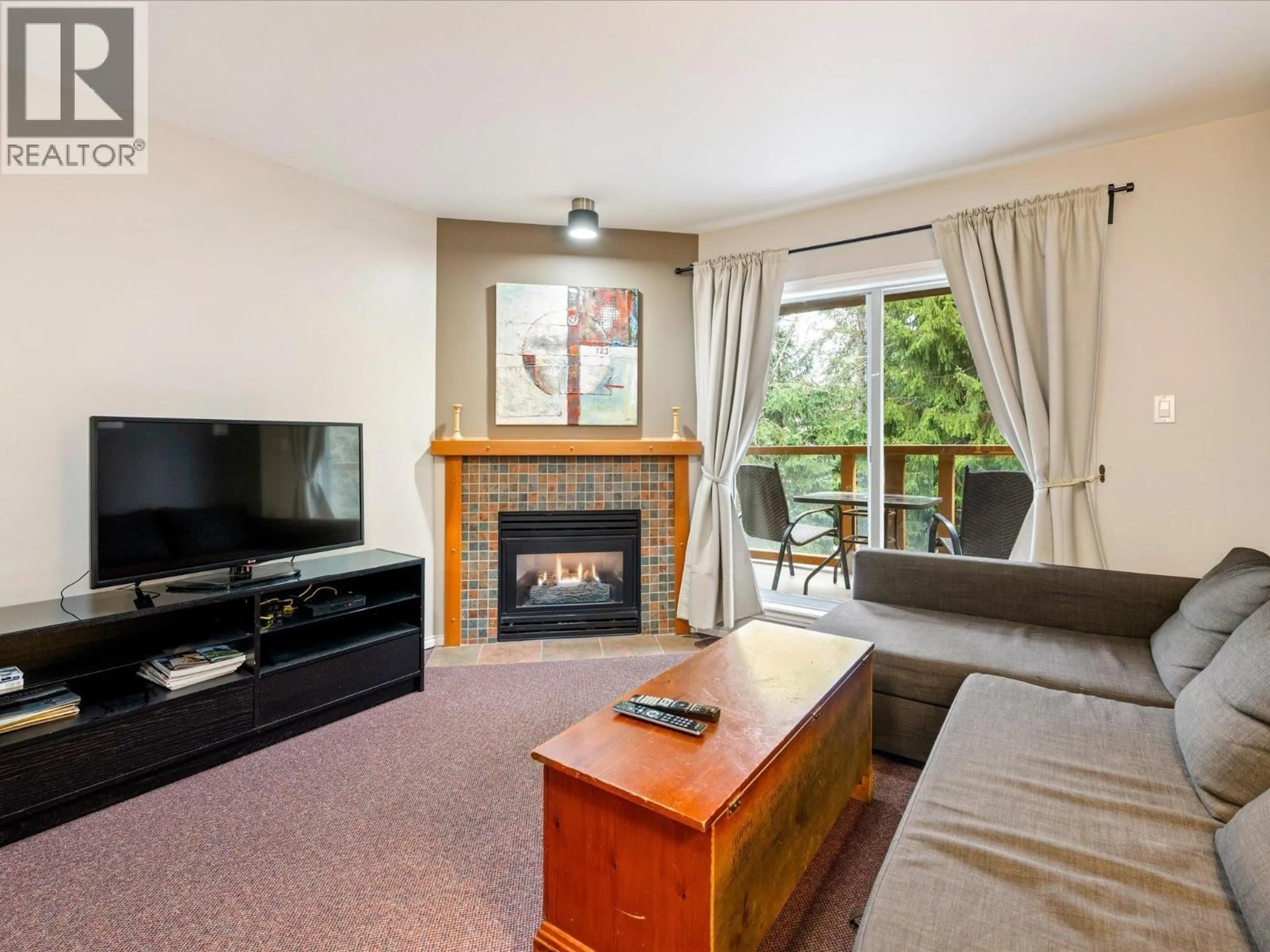 Living room with furniture, wood/laminate floor for 112 - 4388 NORTHLANDS BOULEVARD, Whistler British Columbia V8E1C6