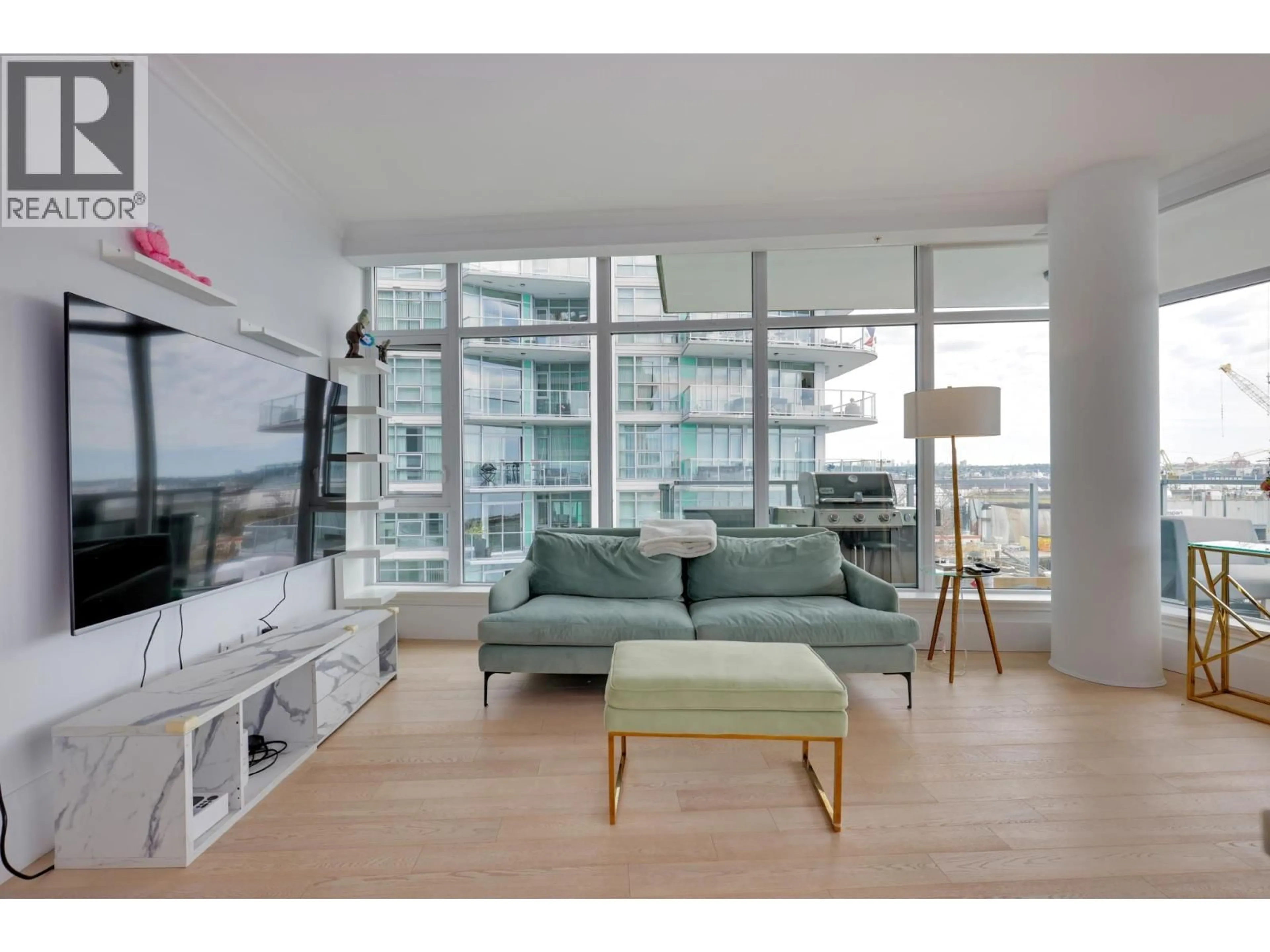 Living room with furniture, wood/laminate floor for 501 - 185 VICTORY SHIP WAY, North Vancouver British Columbia V7L0G2