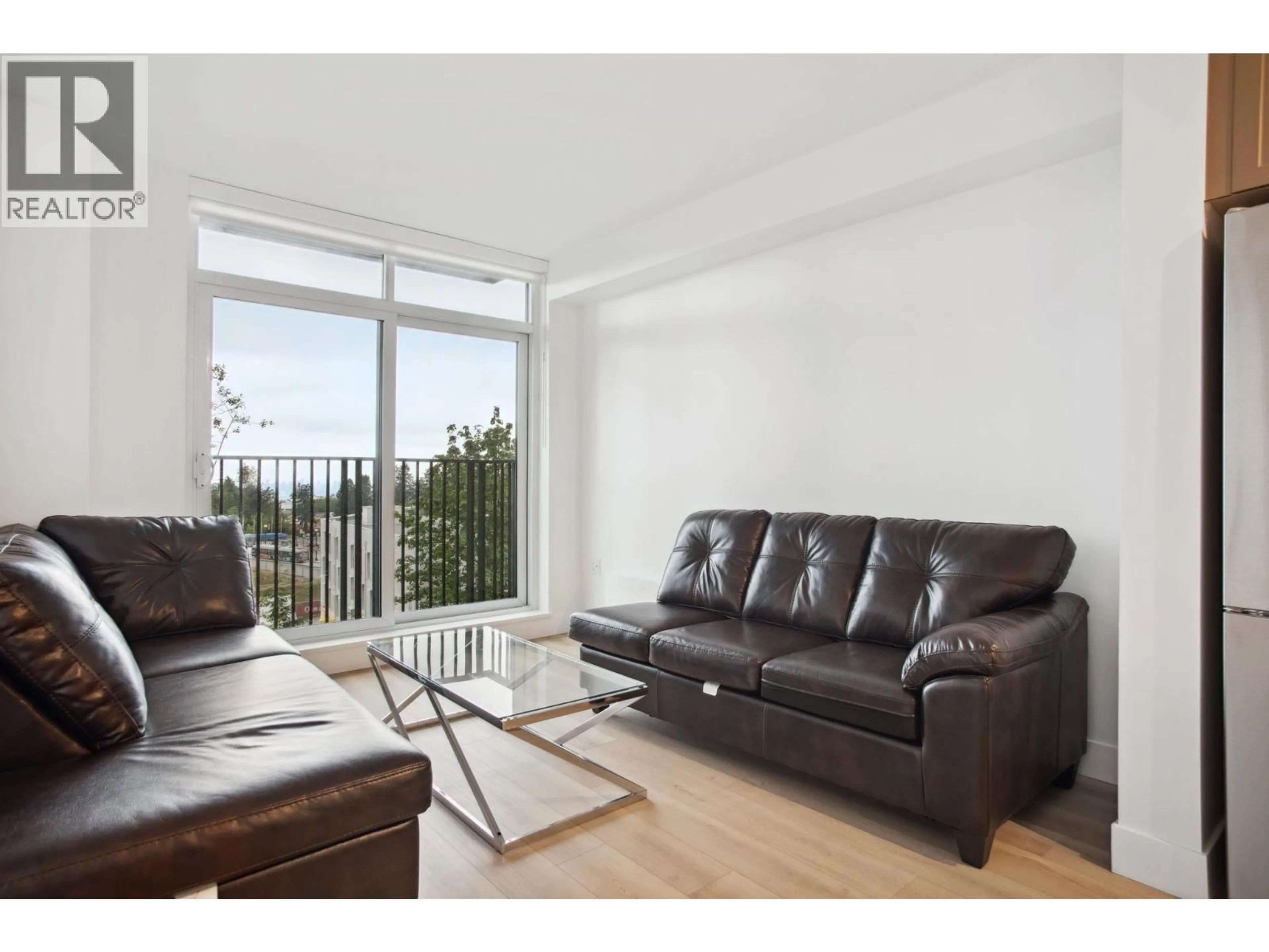 Living room with furniture, wood/laminate floor for 711 - 8750 UNIVERSITY CRESCENT, Burnaby British Columbia V5A0G9