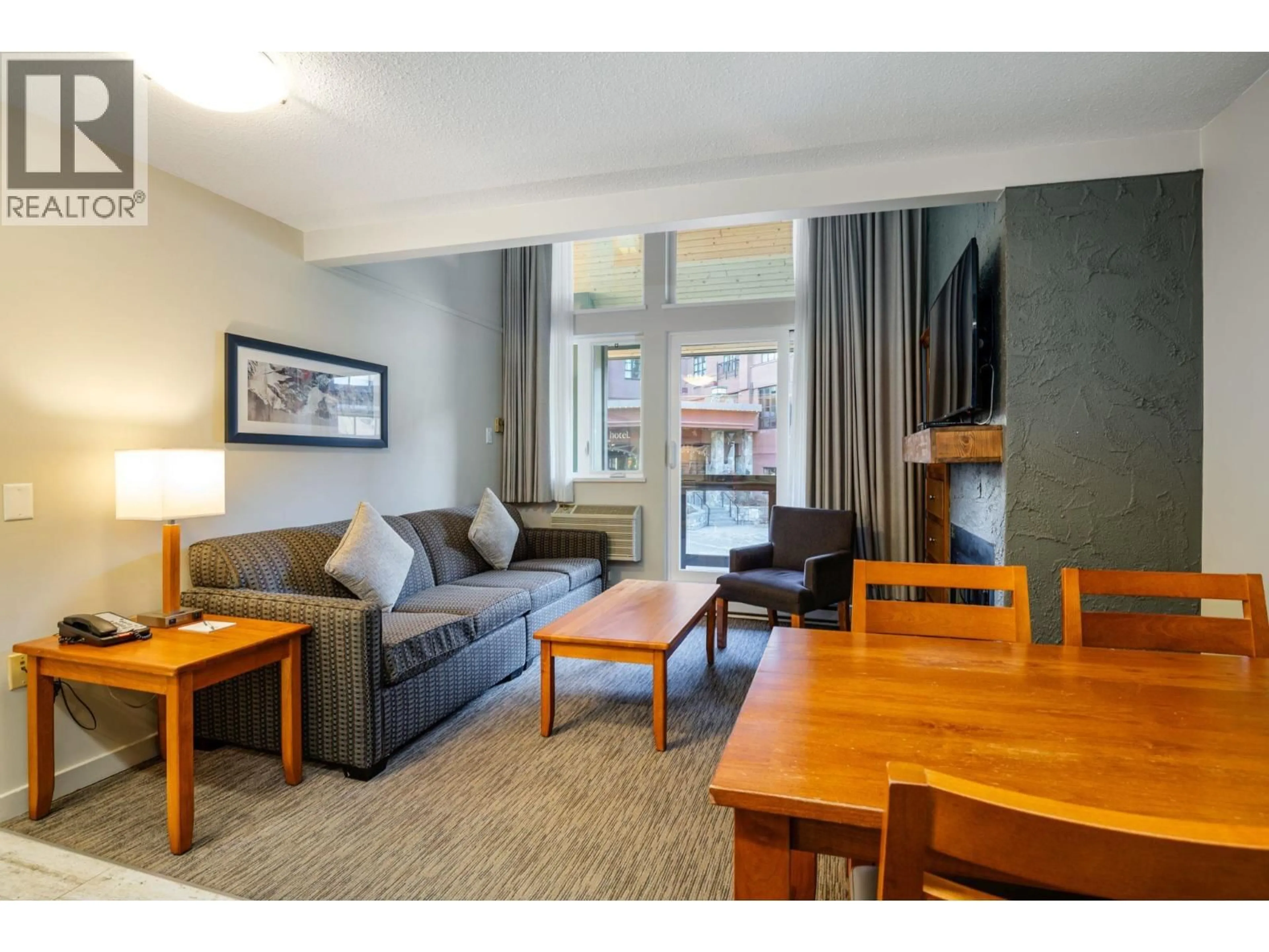 Living room with furniture, wood/laminate floor for 210 - 4420 SUNDIAL PLACE, Whistler British Columbia V8E1G6