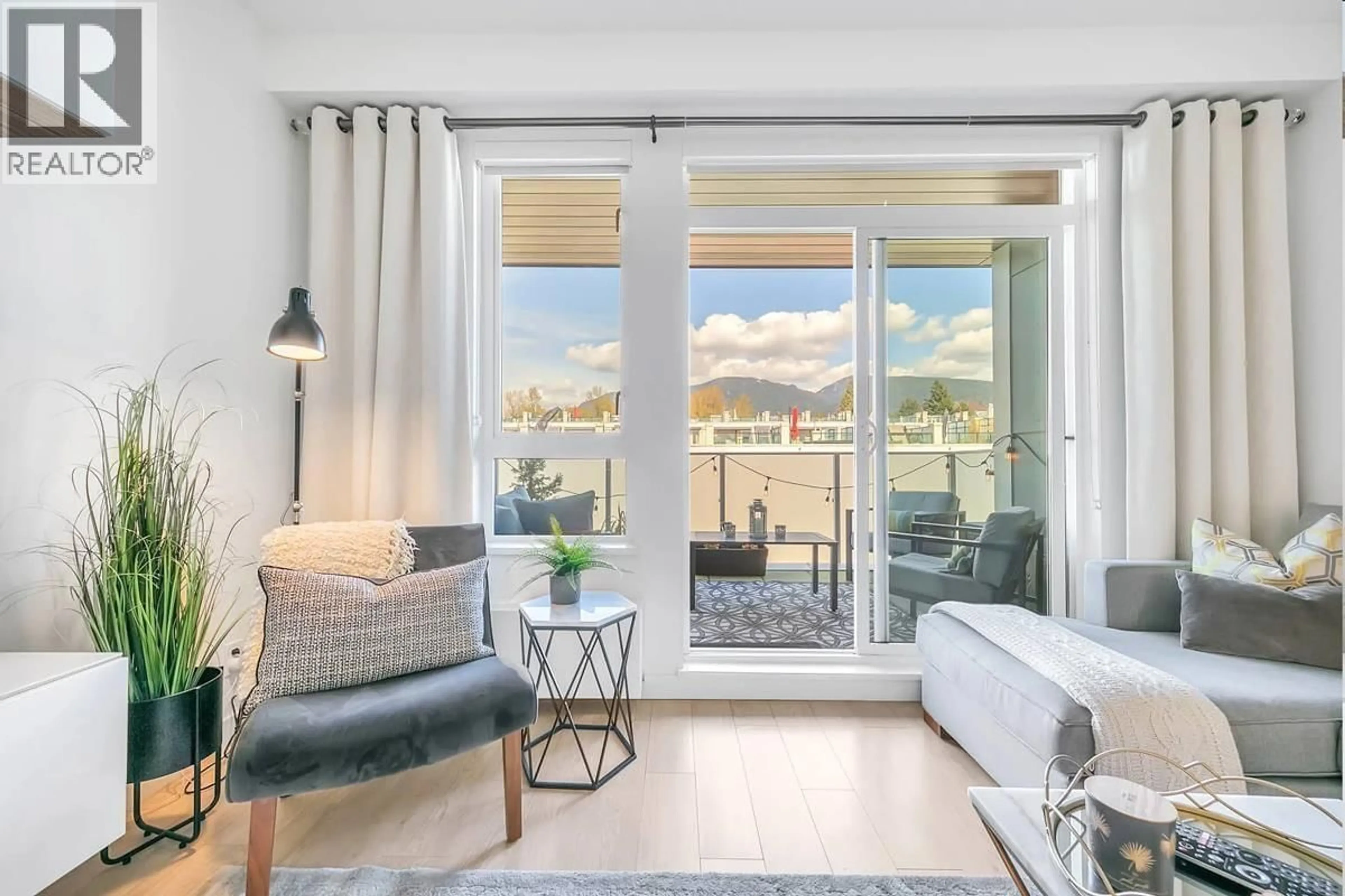 Living room with furniture, wood/laminate floor for 410 - 711 14TH STREET, North Vancouver British Columbia V7M3E8