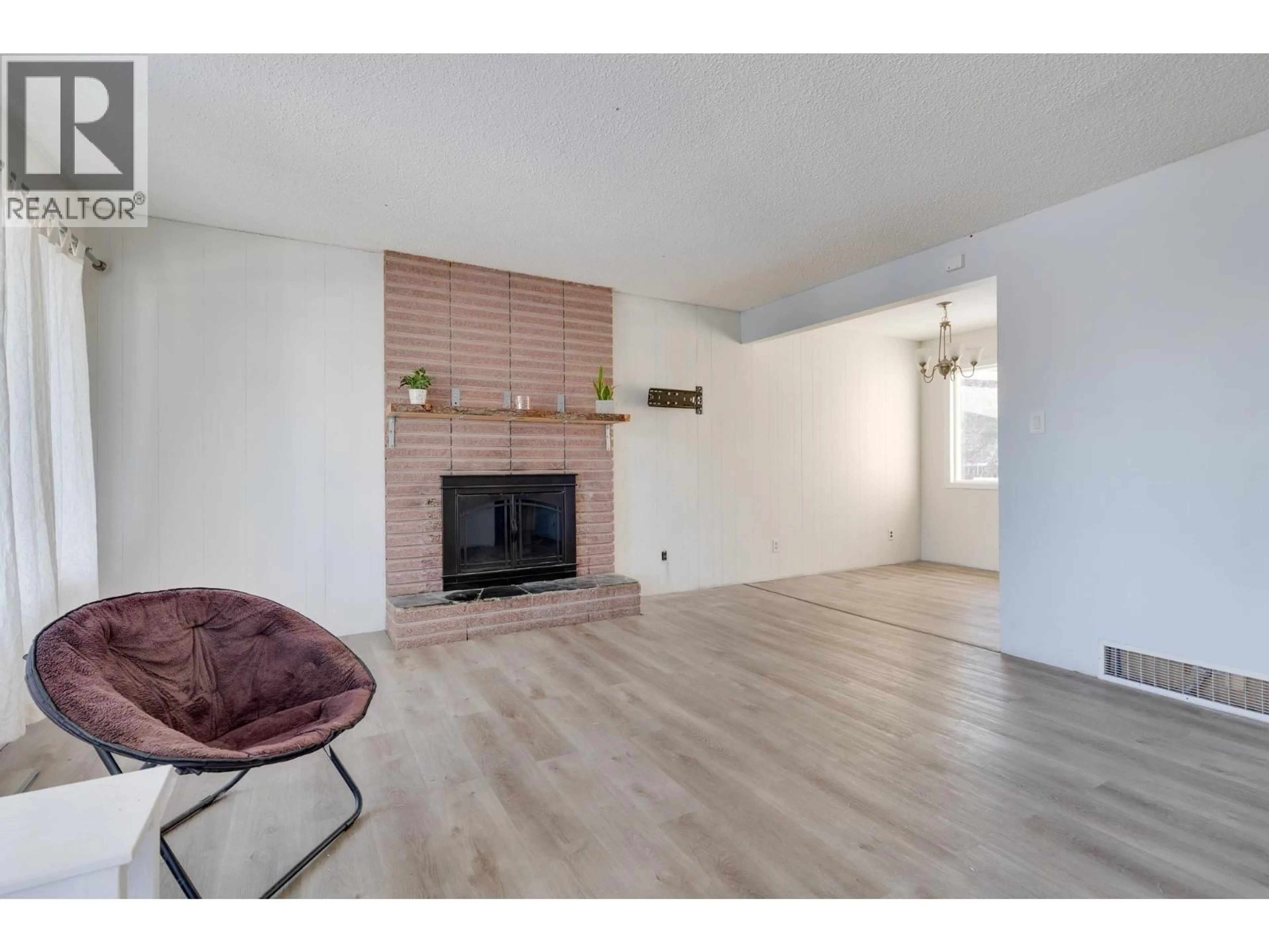 Living room with furniture, wood/laminate floor for 4051 DAVIS ROAD, Prince George British Columbia V2N5K9