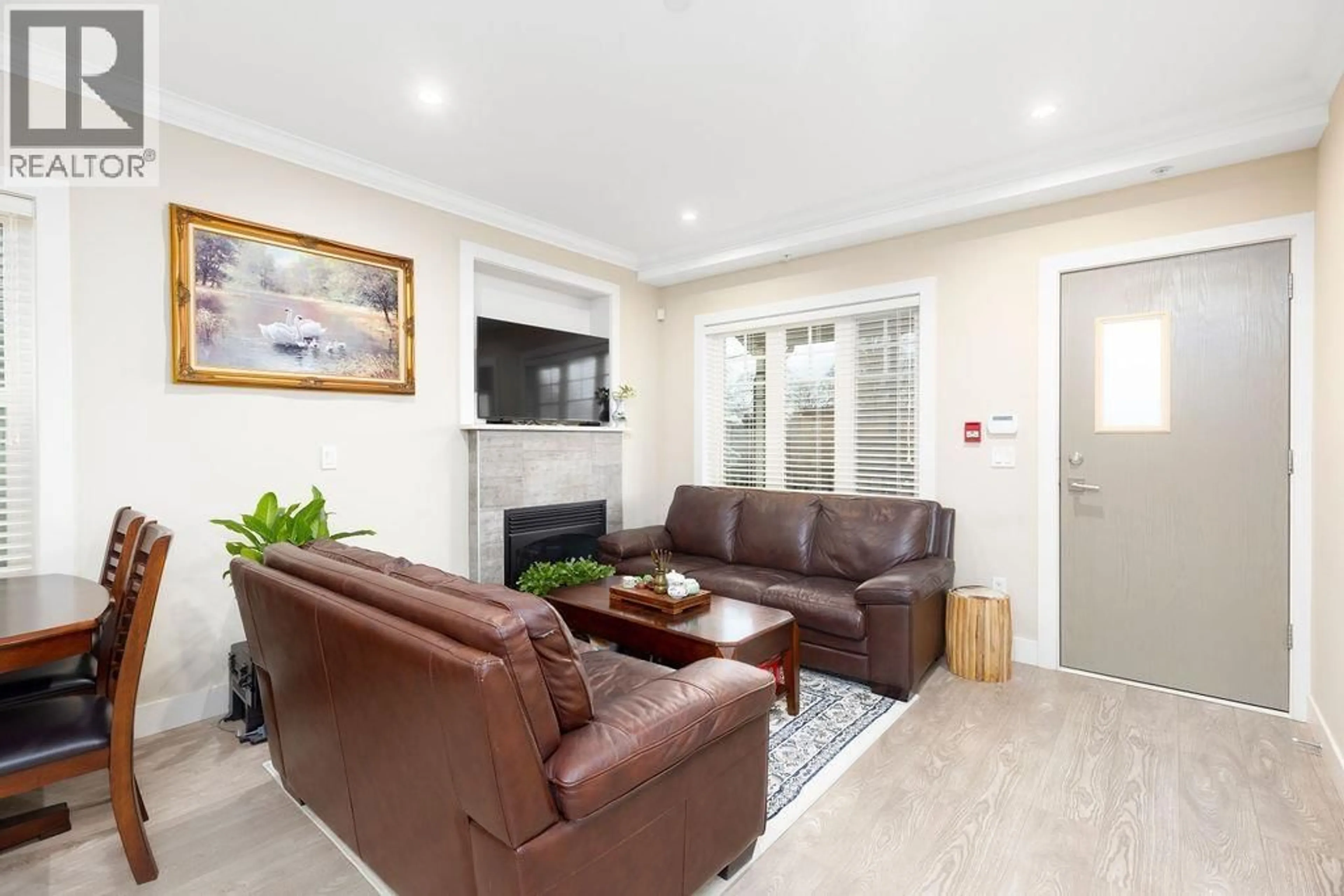 Living room with furniture, wood/laminate floor for 201 - 4577 SLOCAN STREET, Vancouver British Columbia V5R1Z8