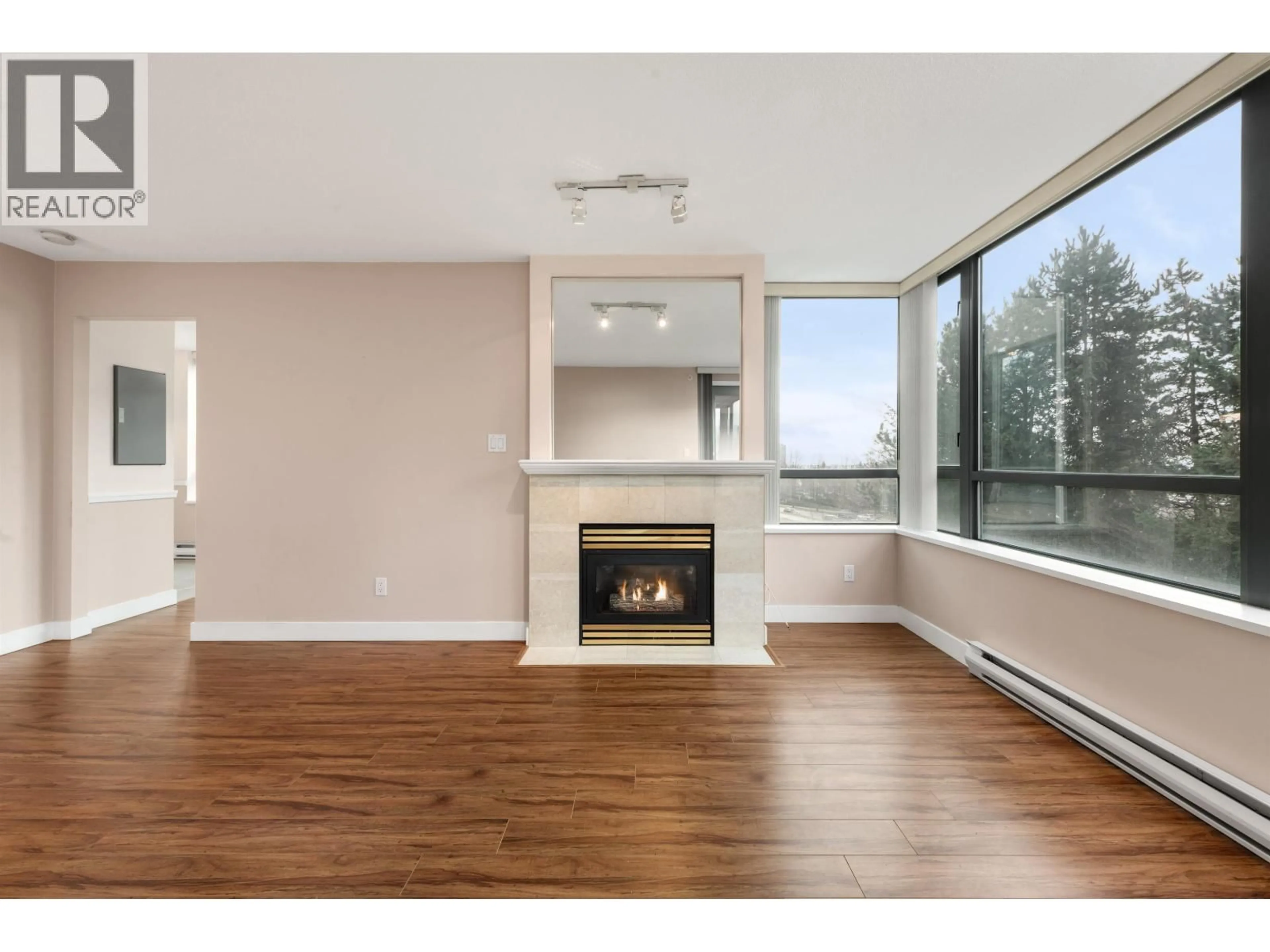 Living room with furniture, wood/laminate floor for 306 - 6622 SOUTHOAKS CRESCENT, Burnaby British Columbia V5E4K2