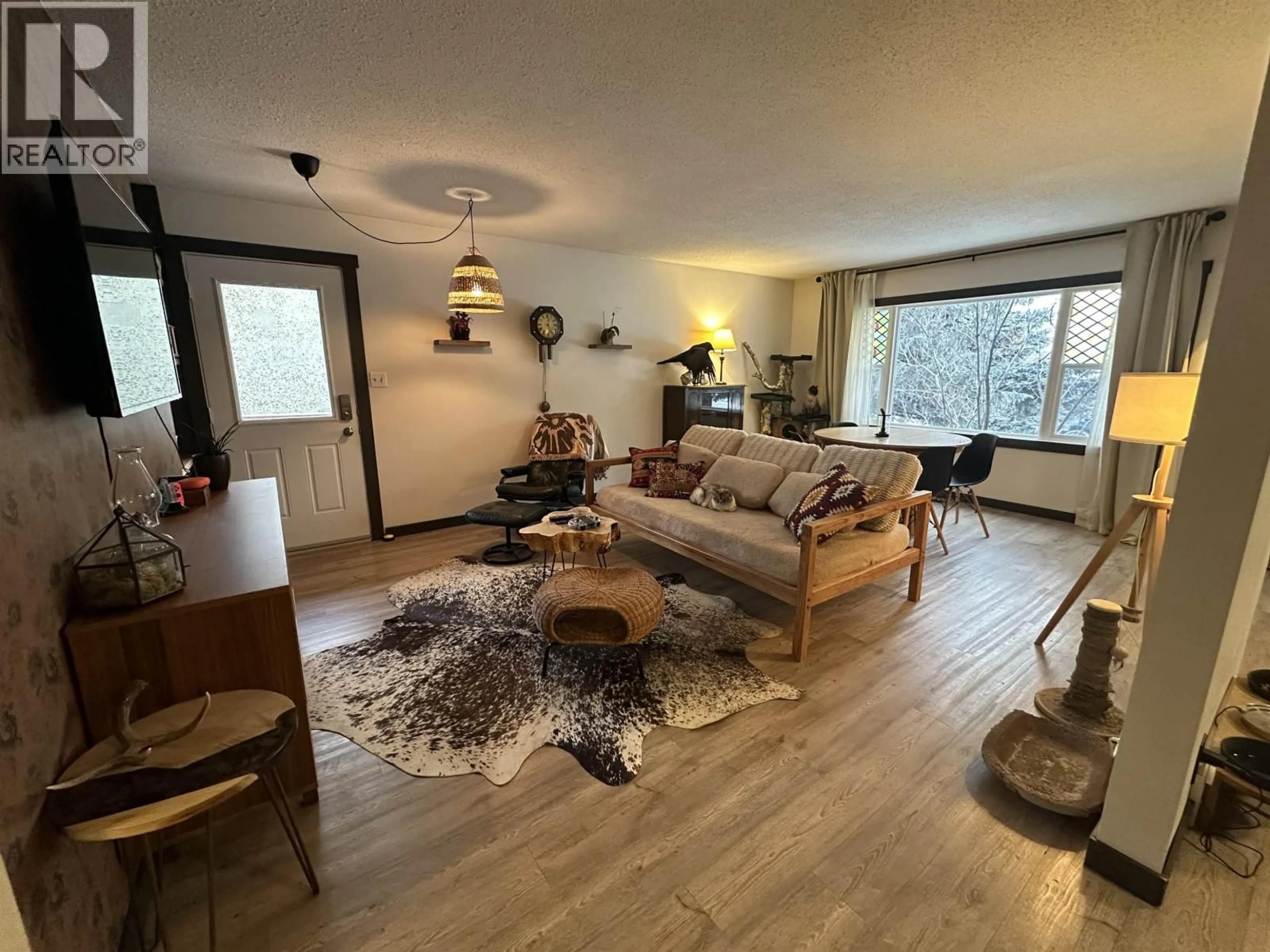 Living room with furniture, wood/laminate floor for 11107 102 AVENUE, Fort St. John British Columbia V1J2G2