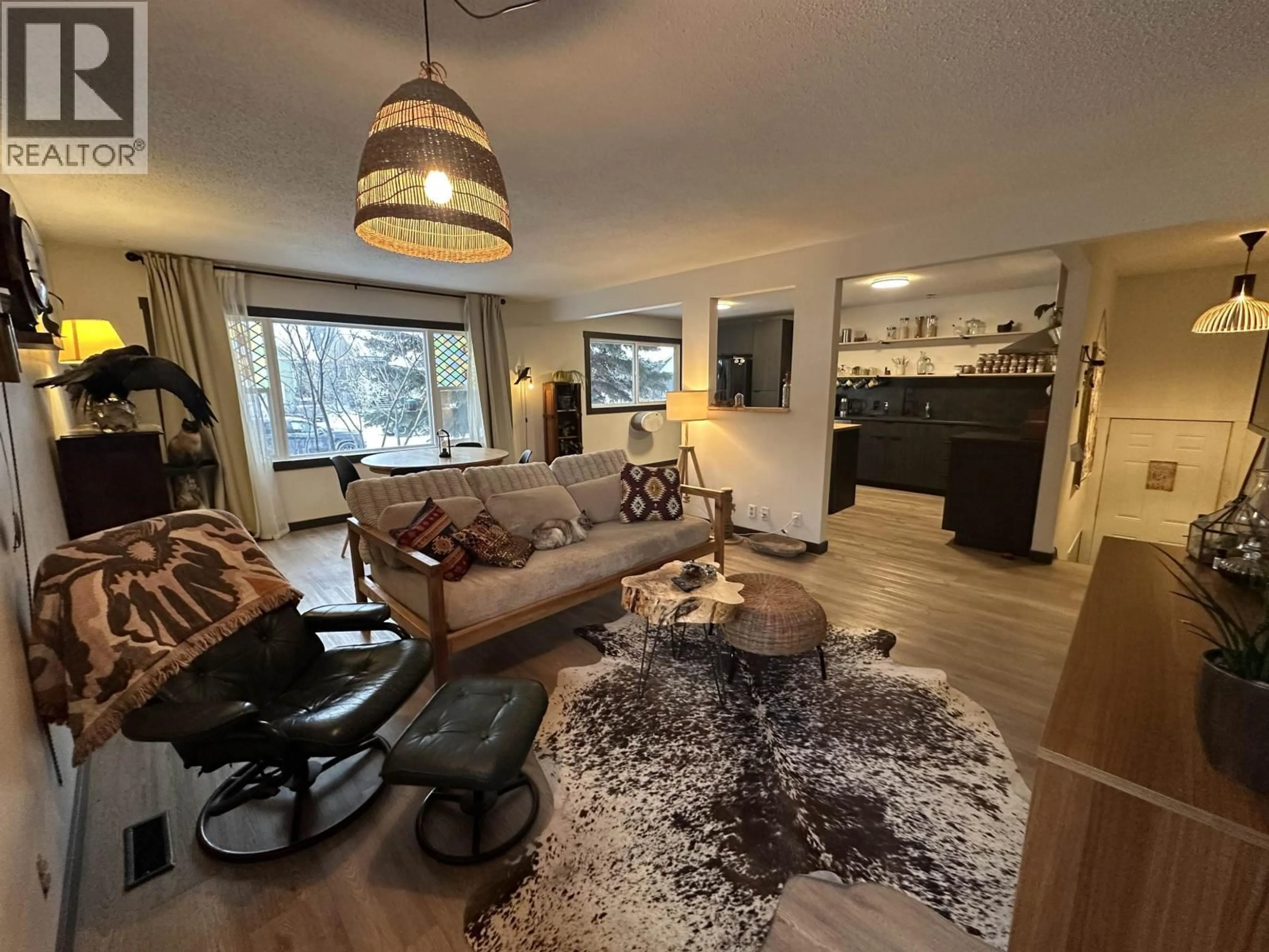 Living room with furniture, wood/laminate floor for 11107 102 AVENUE, Fort St. John British Columbia V1J2G2