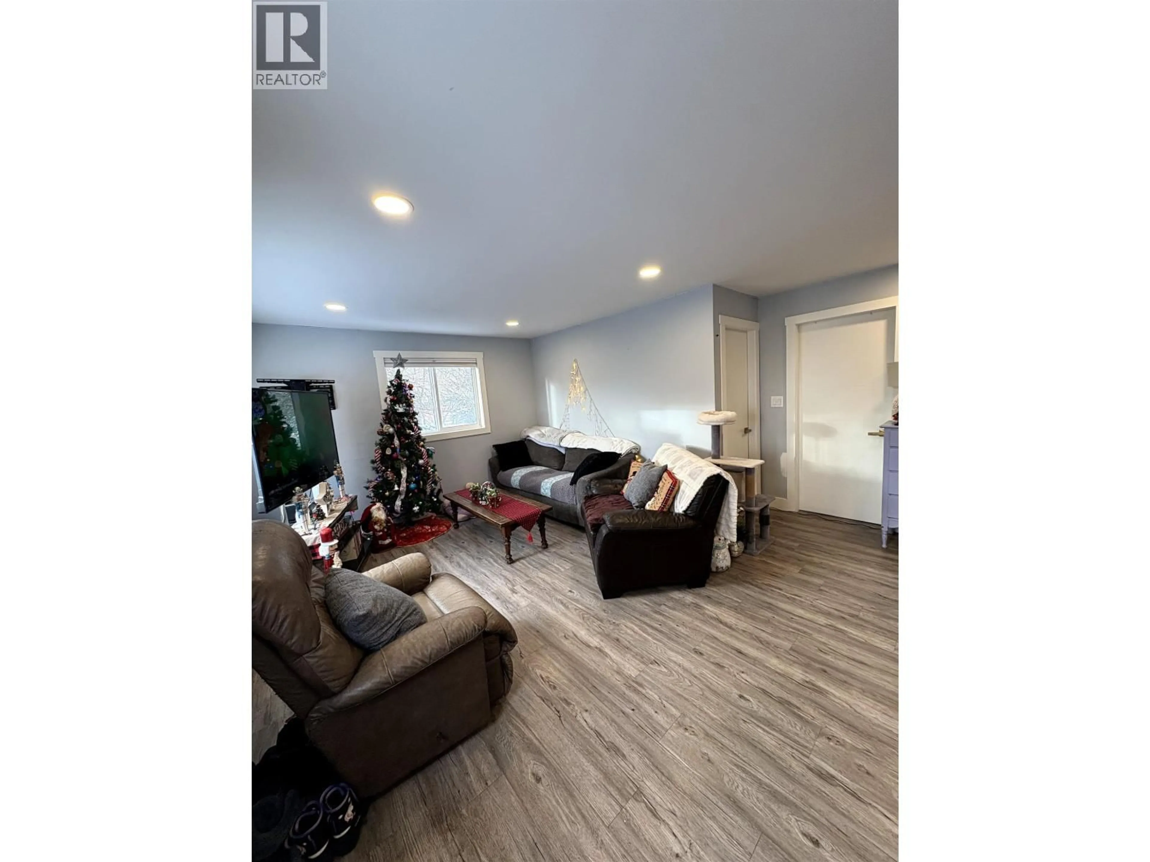 Living room with furniture, wood/laminate floor for 7802 GISCOME ROAD, Prince George British Columbia V2N6V1