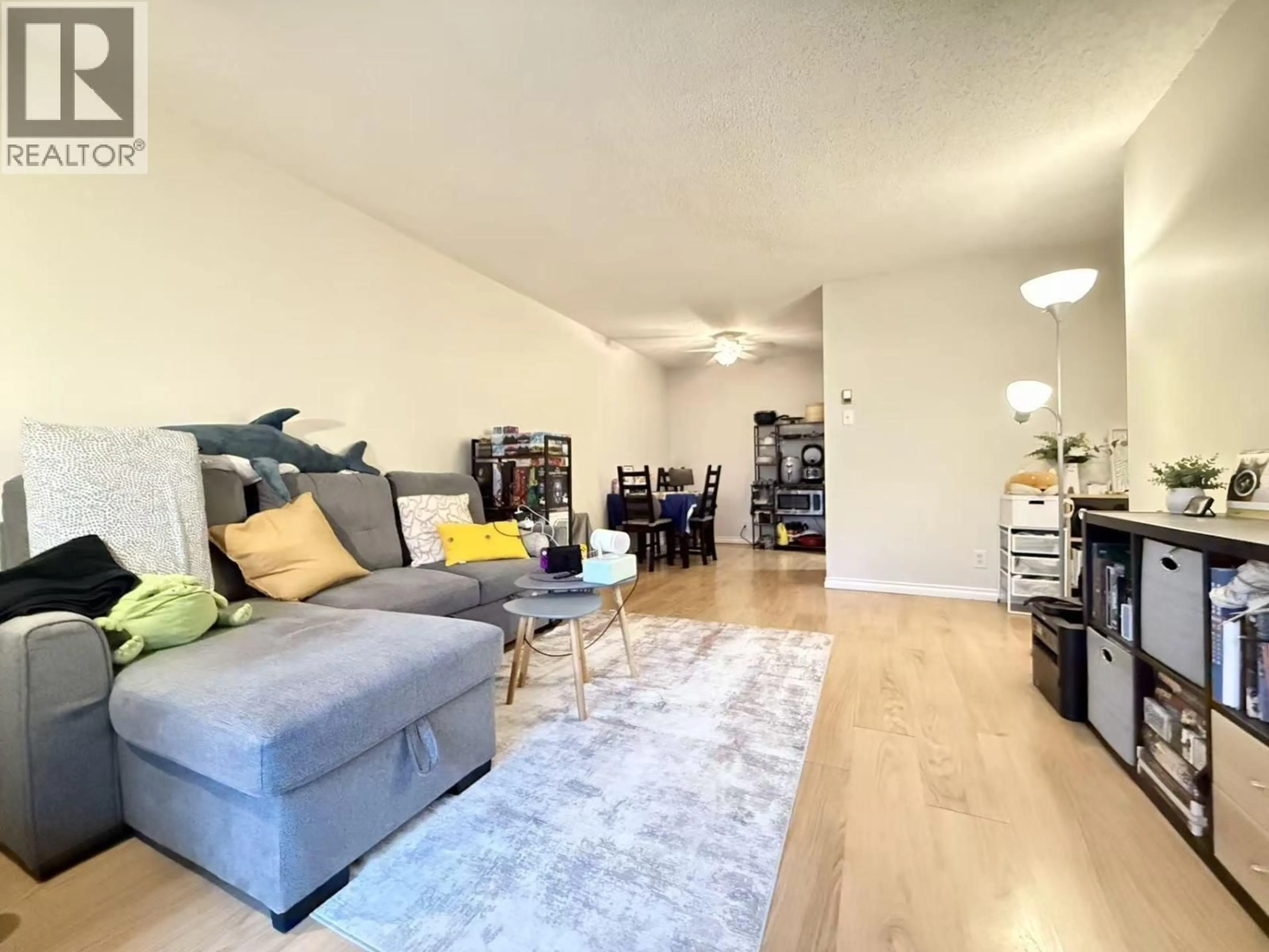 Living room with furniture, wood/laminate floor for 105 - 8511 ACKROYD ROAD, Richmond British Columbia V6X3E7