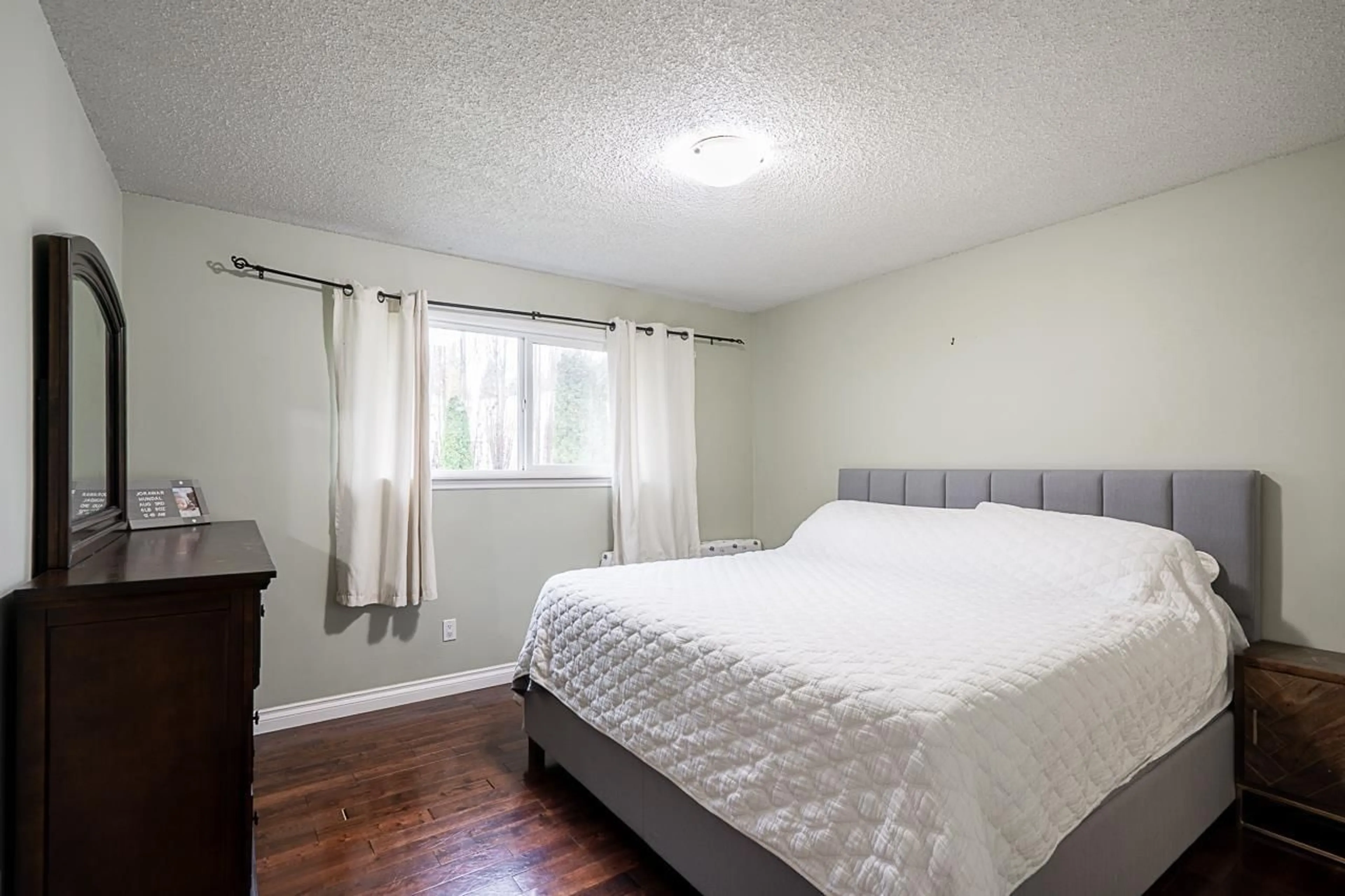 Bedroom with bed, wood/laminate floor for 20510 48A AVENUE, Langley British Columbia V3A3P3