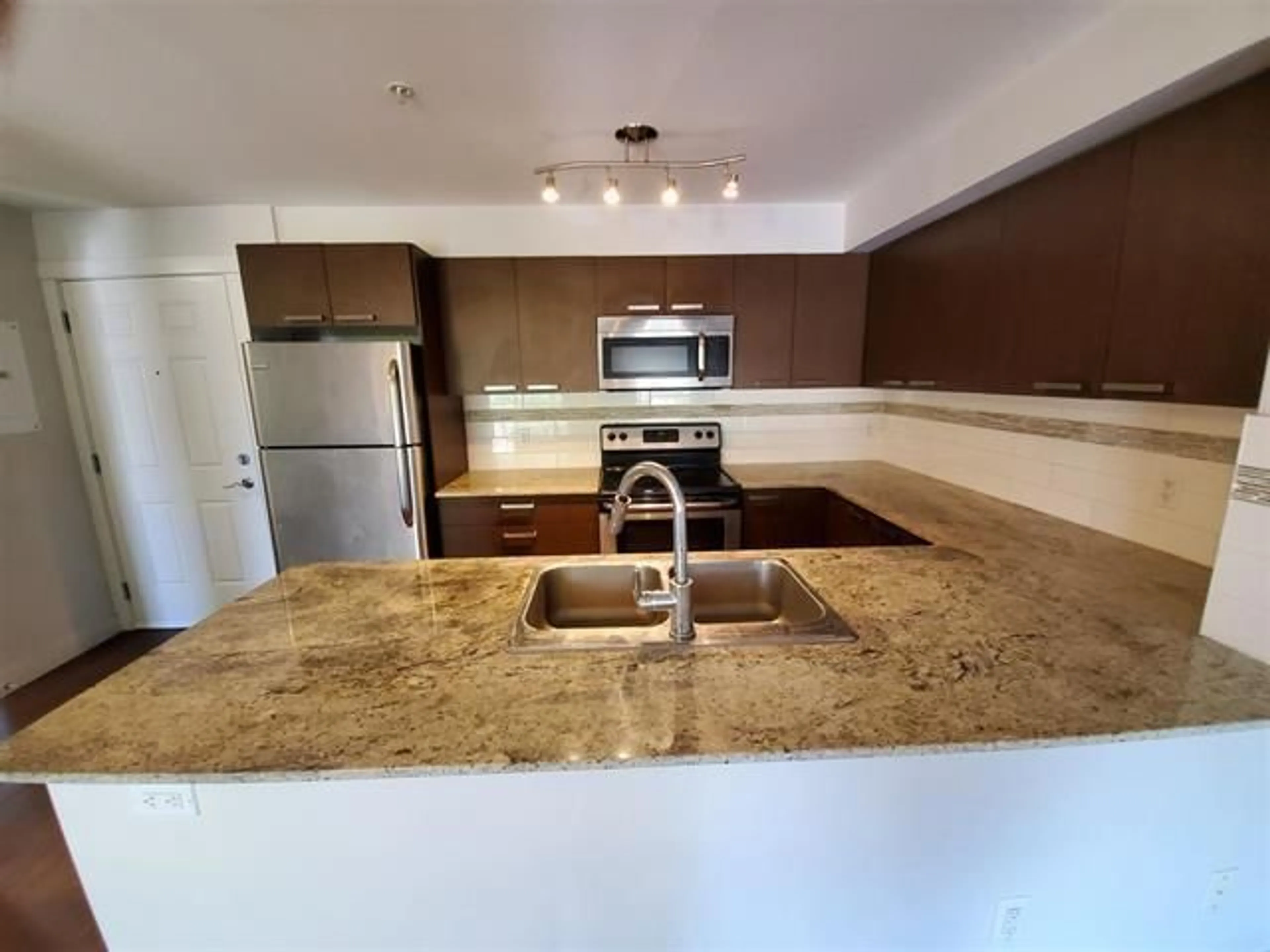 Open concept kitchen, ceramic/tile floor for 315 - 13883 LAUREL DRIVE, Surrey British Columbia V3T1A8
