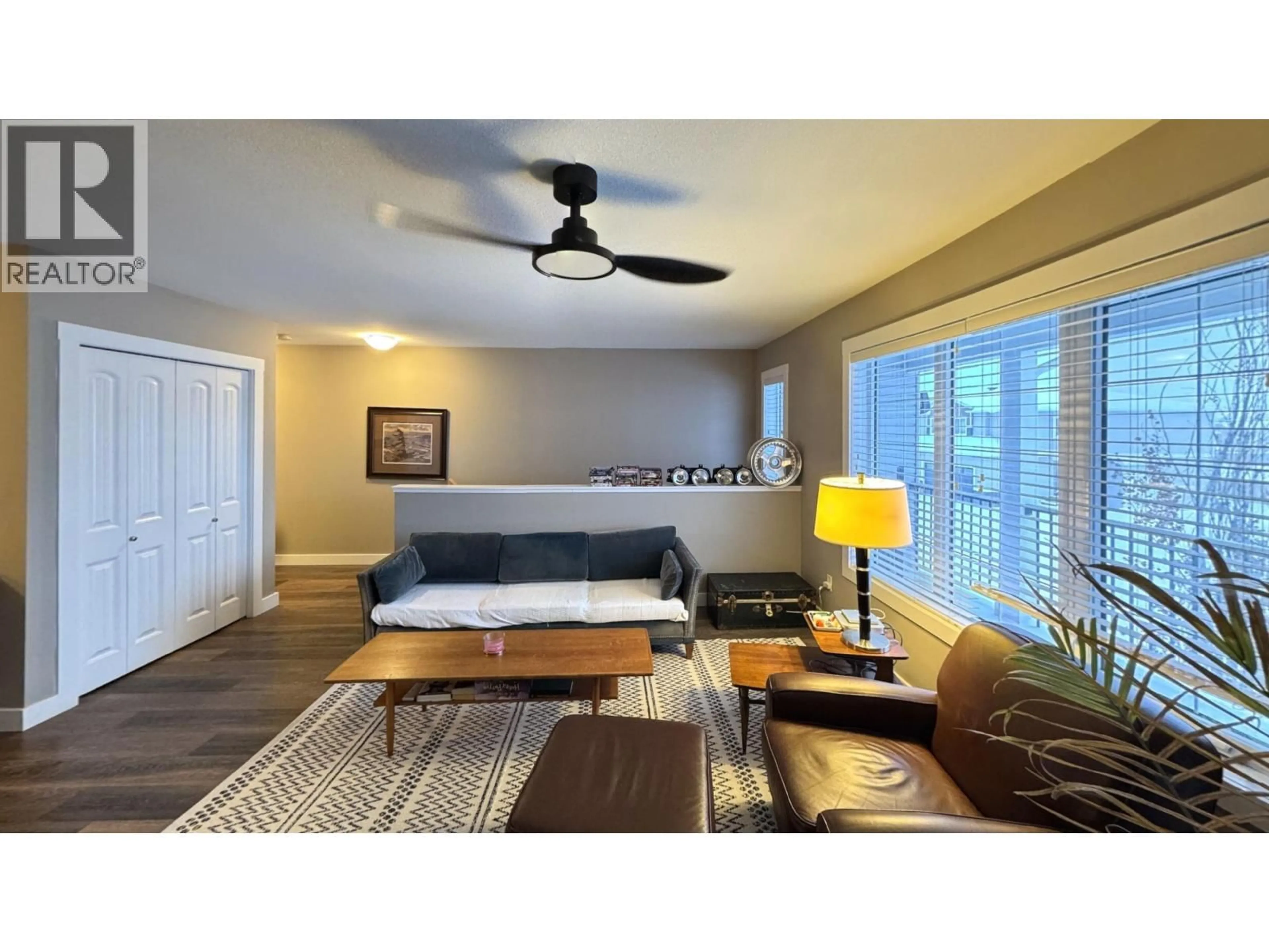 Living room with furniture, wood/laminate floor for 120 - 10104 114A AVENUE, Fort St. John British Columbia V1J0K5