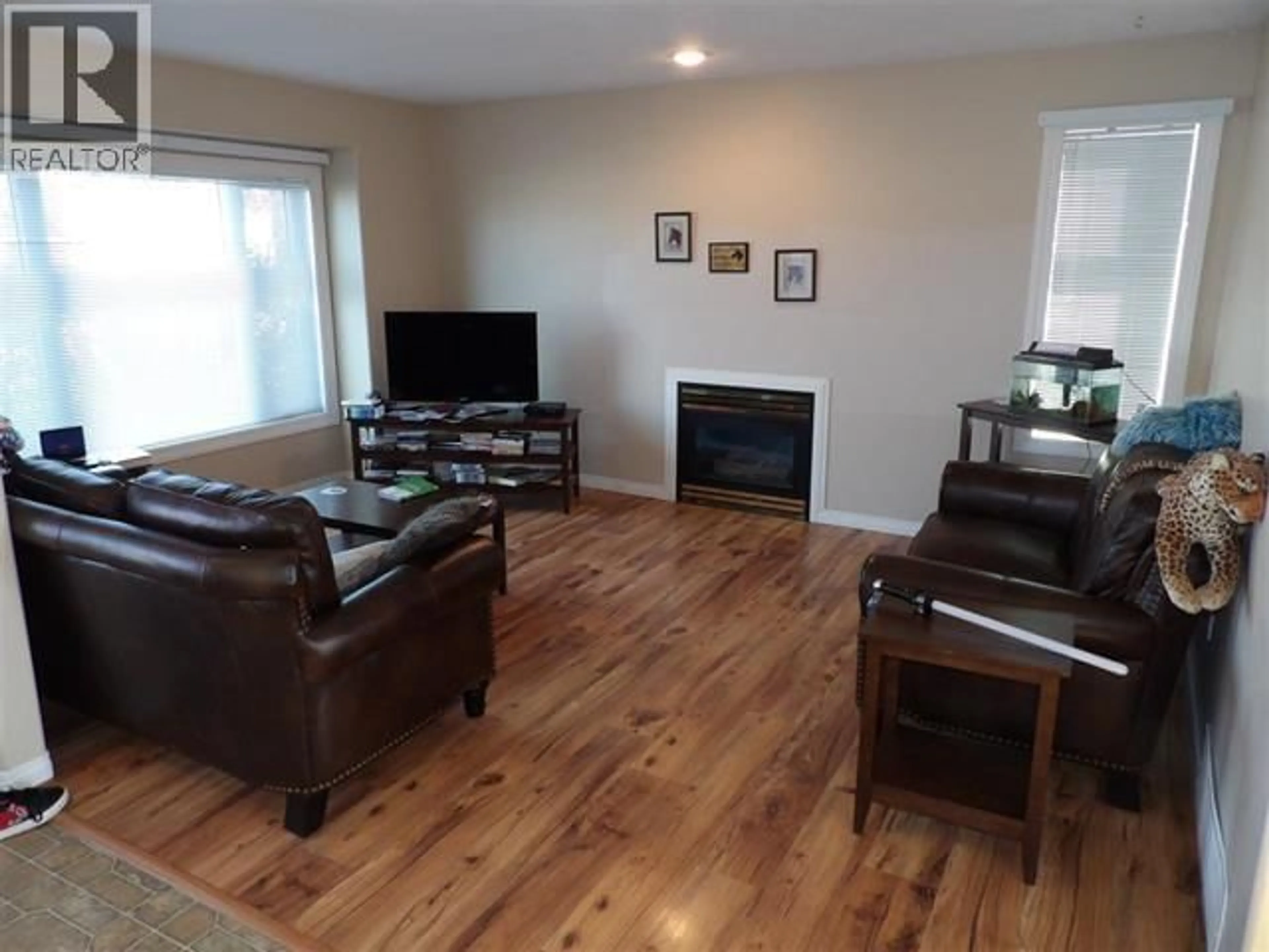 Living room with furniture, wood/laminate floor for 8912 81 STREET, Fort St. John British Columbia V1J6T7