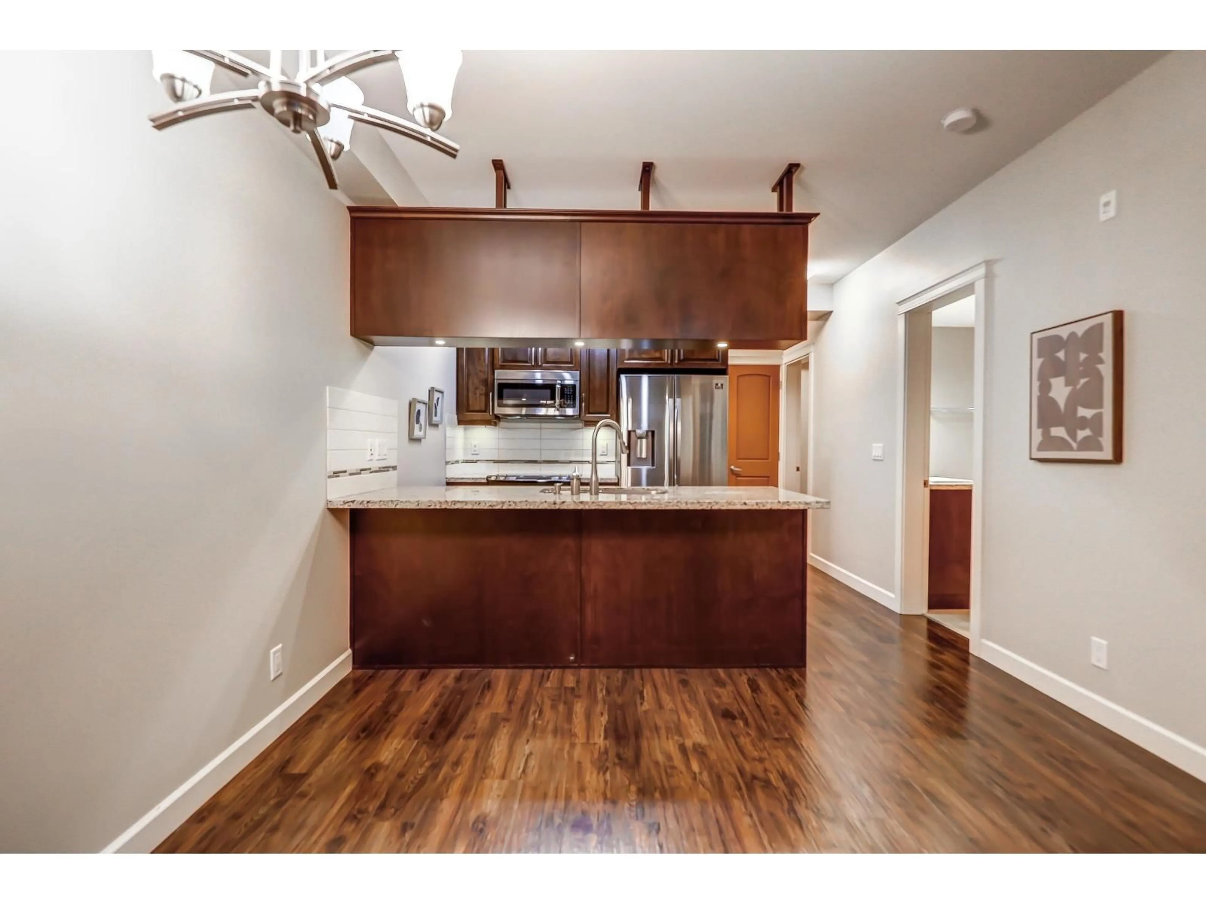 Open concept kitchen, wood/laminate floor for 106 - 8258 207A STREET, Langley British Columbia V2Y0N3